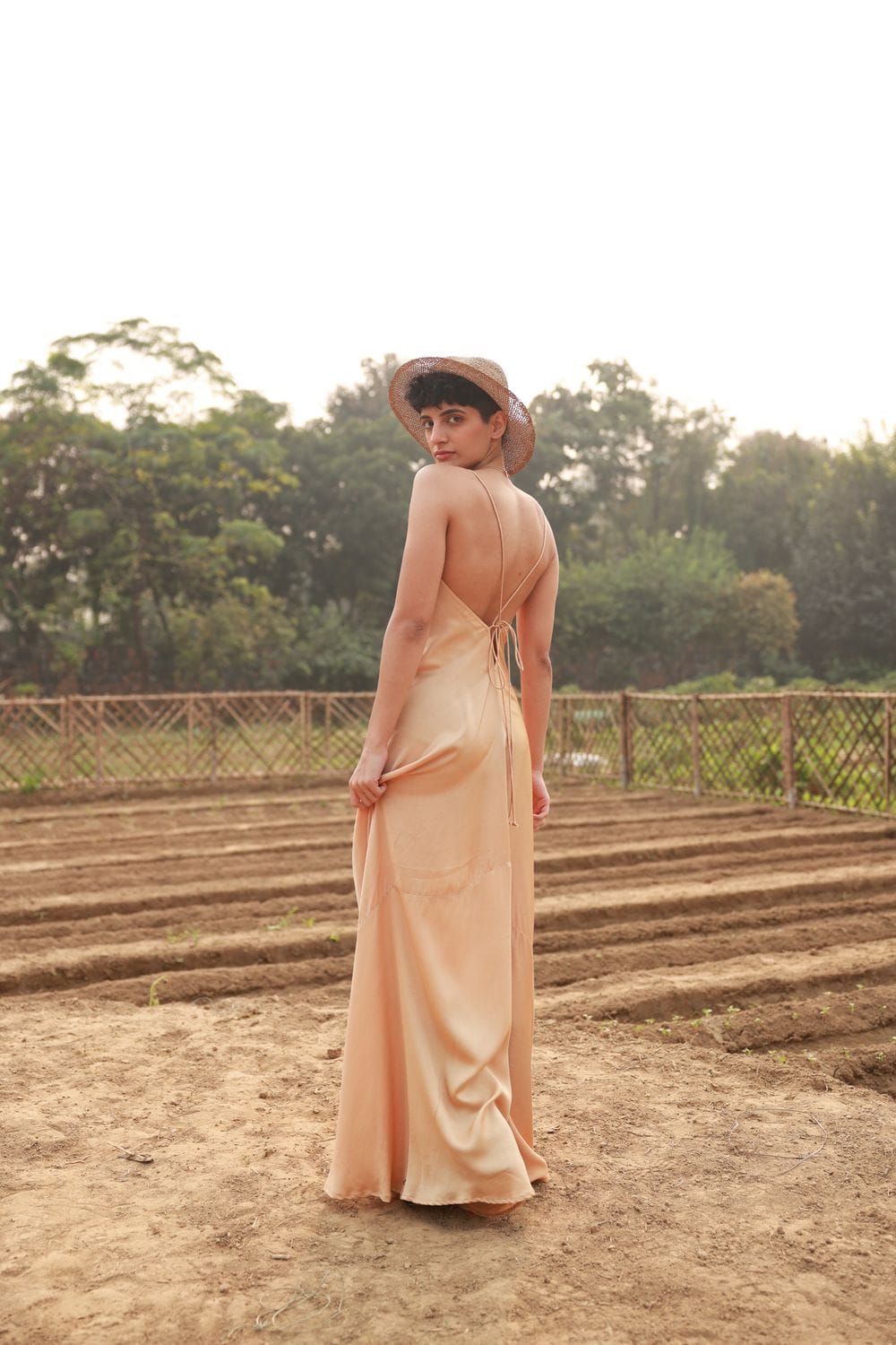 Doodlage Lola beige dress displayed on a hanger, featuring a relaxed fit and subtle fabric texture.