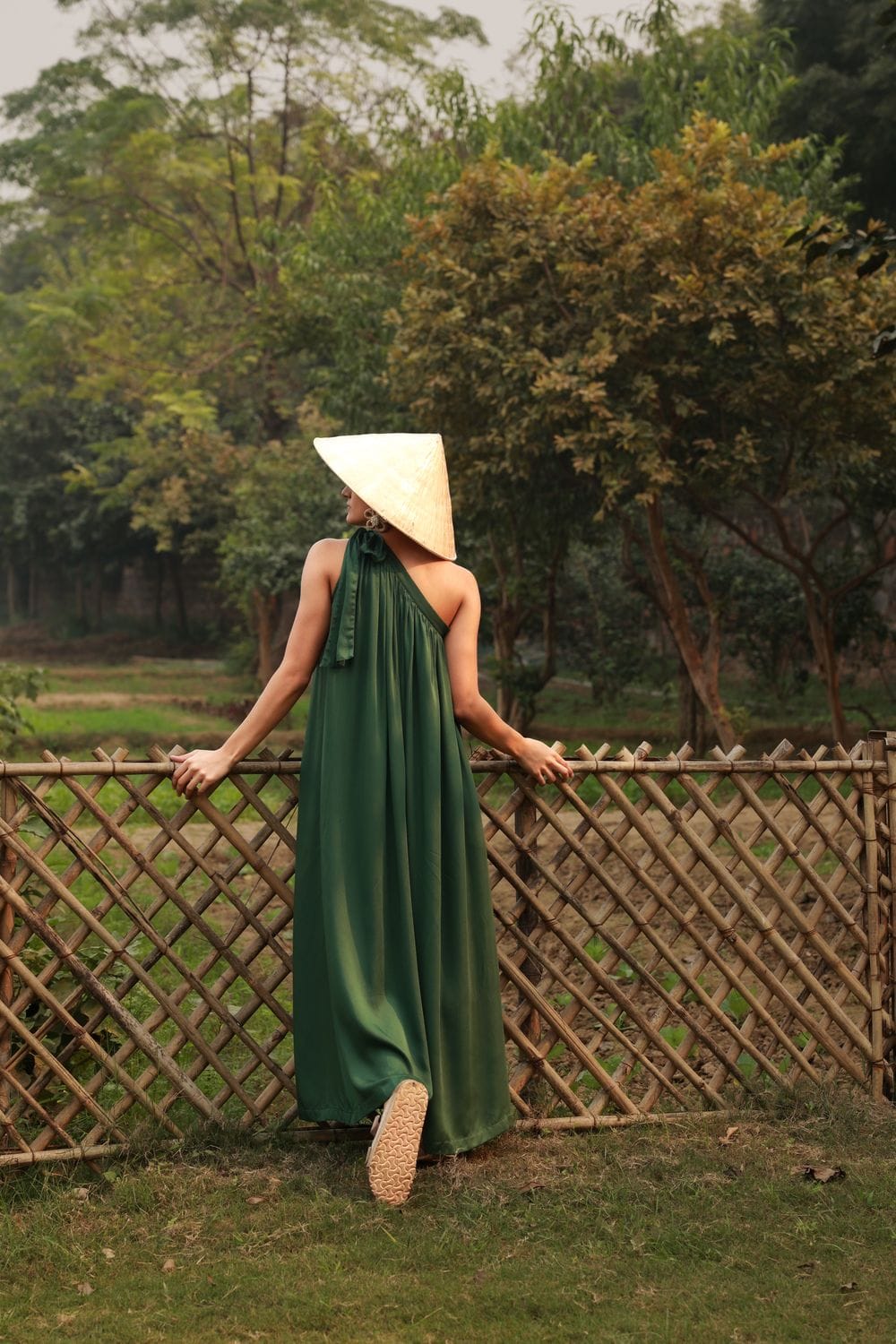 Doodlage Daryl emerald dress shown on a hanger, featuring a flowing fabric and elegant design.