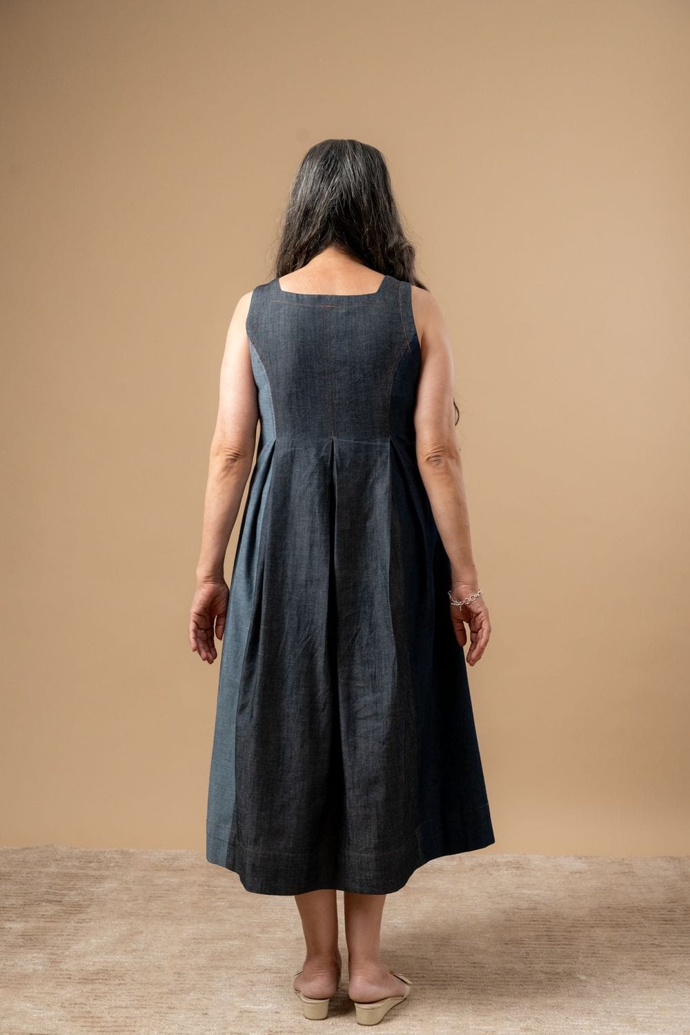 Doodlage Natalie denim dress featuring a stylish, sleeveless design with a fitted waist and casual denim fabric.