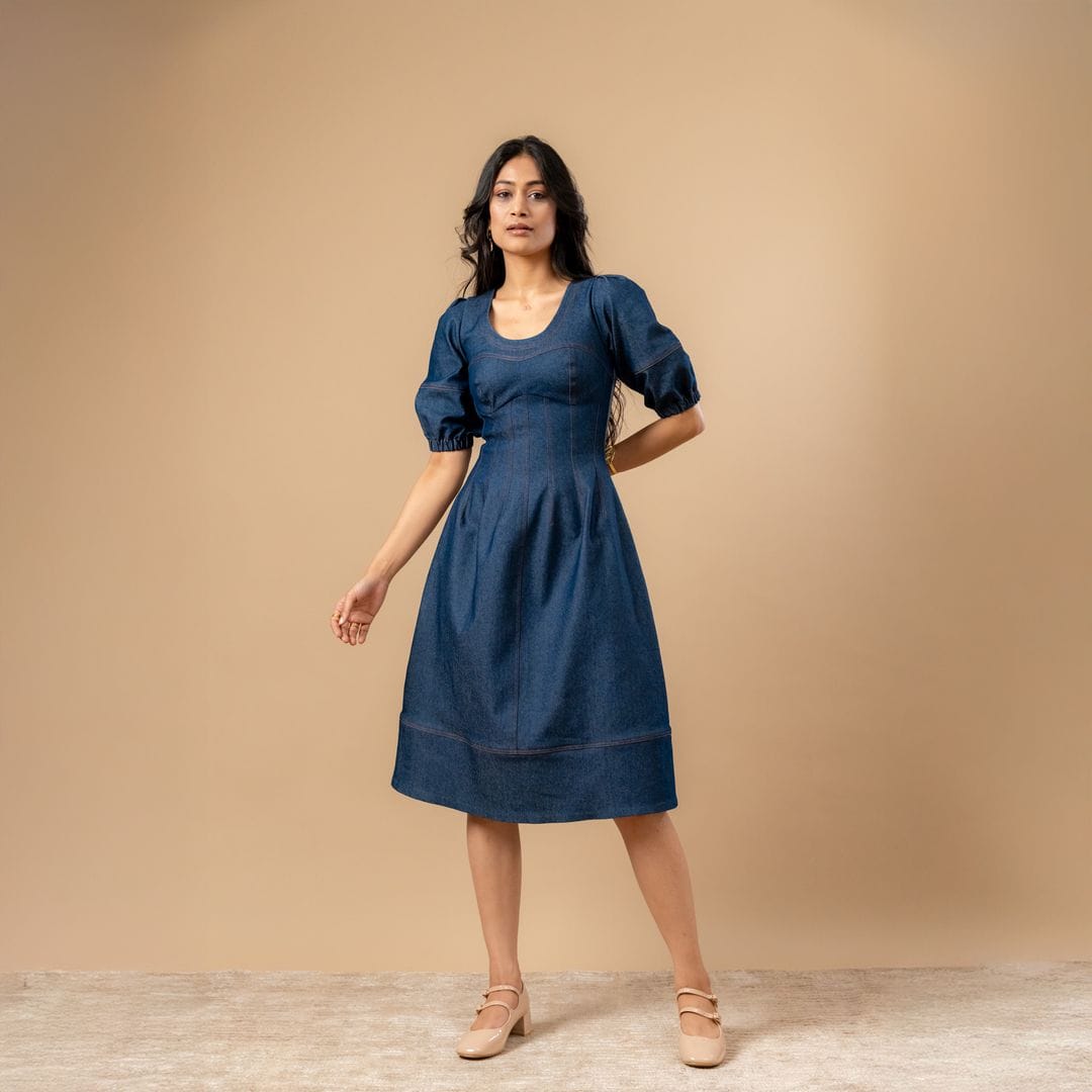 Doodlage Isabelle upcycled denim dress with long sleeves and a fitted silhouette, displayed on a hanger.