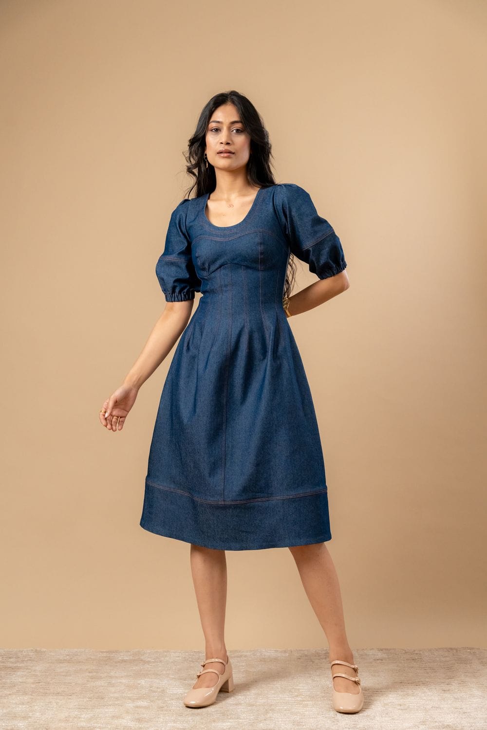 Doodlage Isabelle upcycled denim dress displayed on a hanger, showcasing its casual fit and eco-friendly denim fabric.