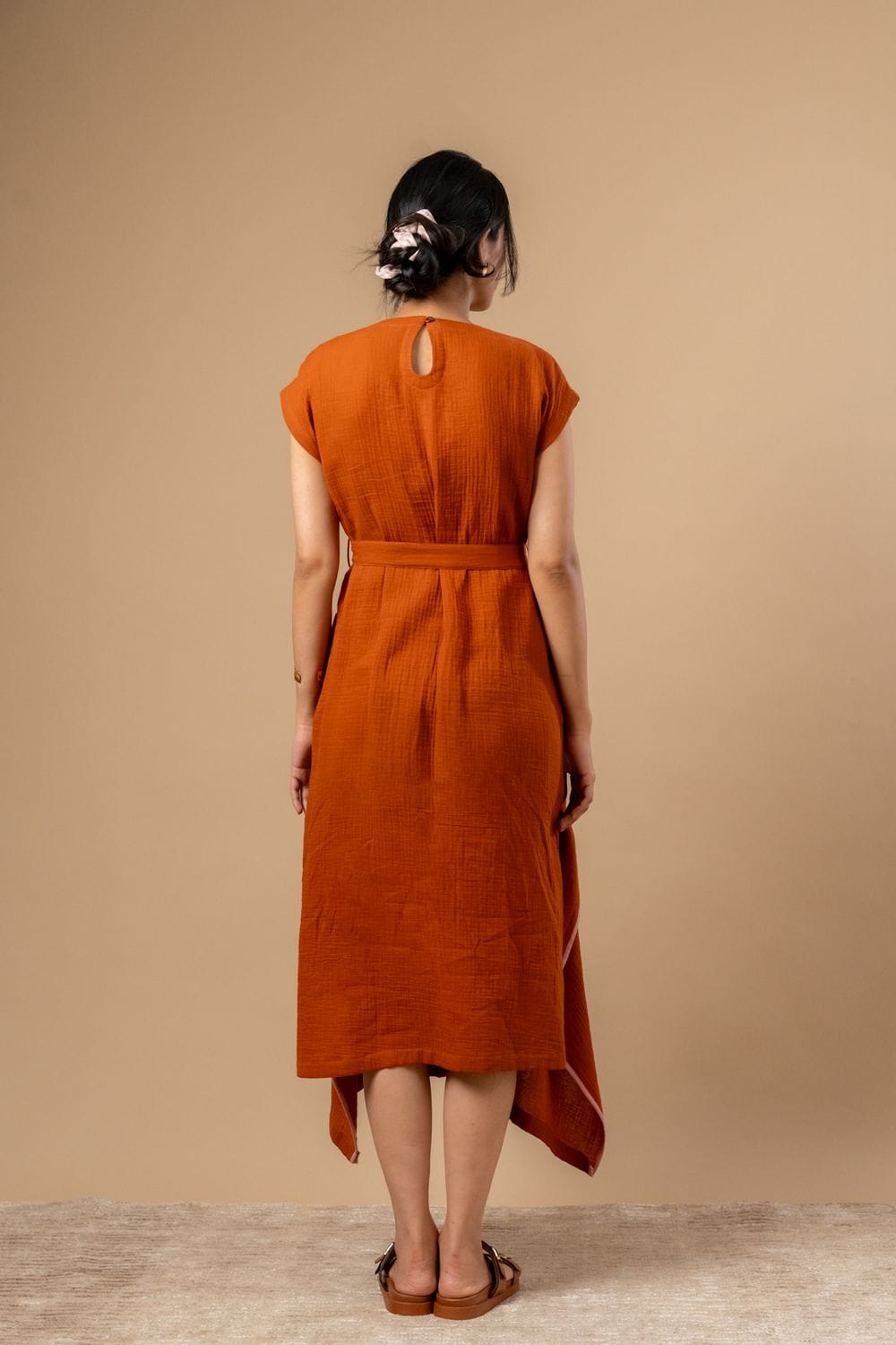 Doodlage Bessie knot dress in earthy tones, featuring a fitted bodice with knot detail and a flowing skirt.