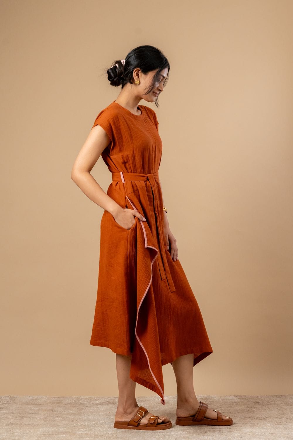 Doodlage Bessie knot dress in earthy tones with a fitted bodice and flowing skirt, showcased on a model.