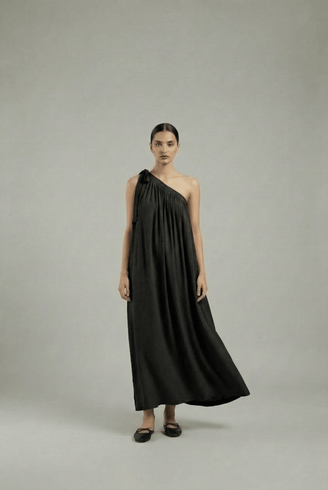 Black Doodlage Daryl dress displayed on a hanger, showcasing its stylish design and fabric details.
