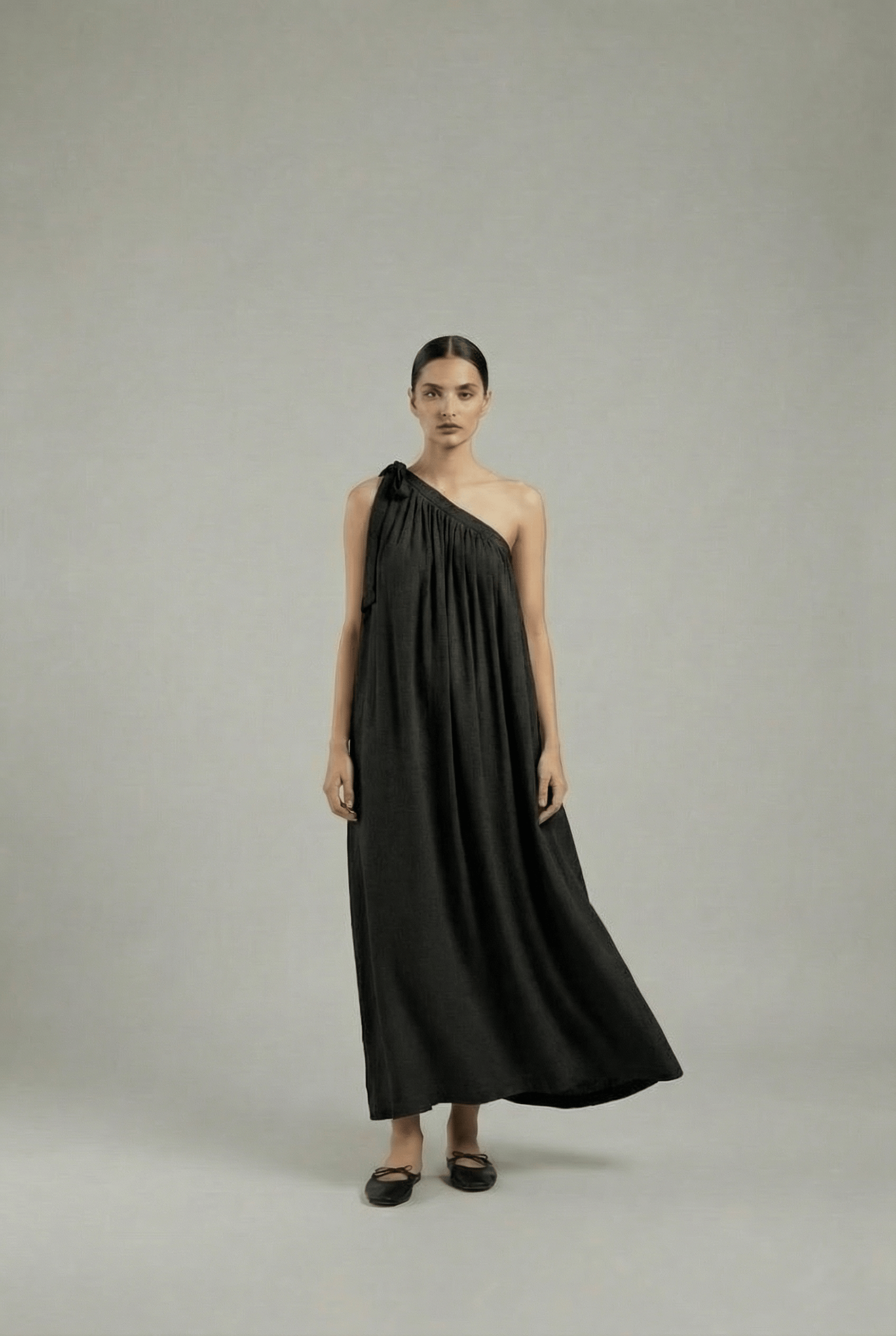 Black Doodlage Daryl dress displayed on a hanger, showcasing its stylish design and fabric details.