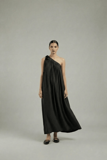 Black Doodlage Daryl dress displayed on a hanger, showcasing its stylish design and fabric details.