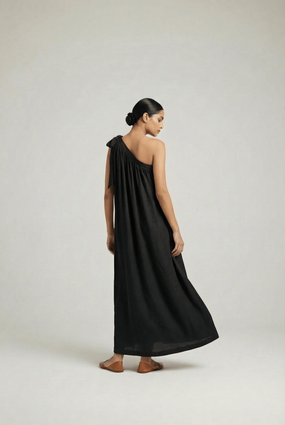 Black Doodlage Daryl dress displayed on a hanger, showcasing its stylish design and fabric details.