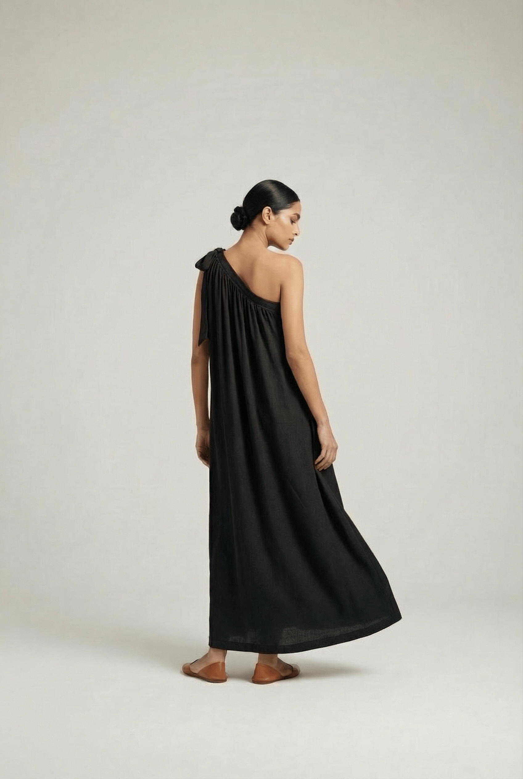 Doodlage Daryl black dress displayed on a hanger, showcasing its sleek design and fabric details.