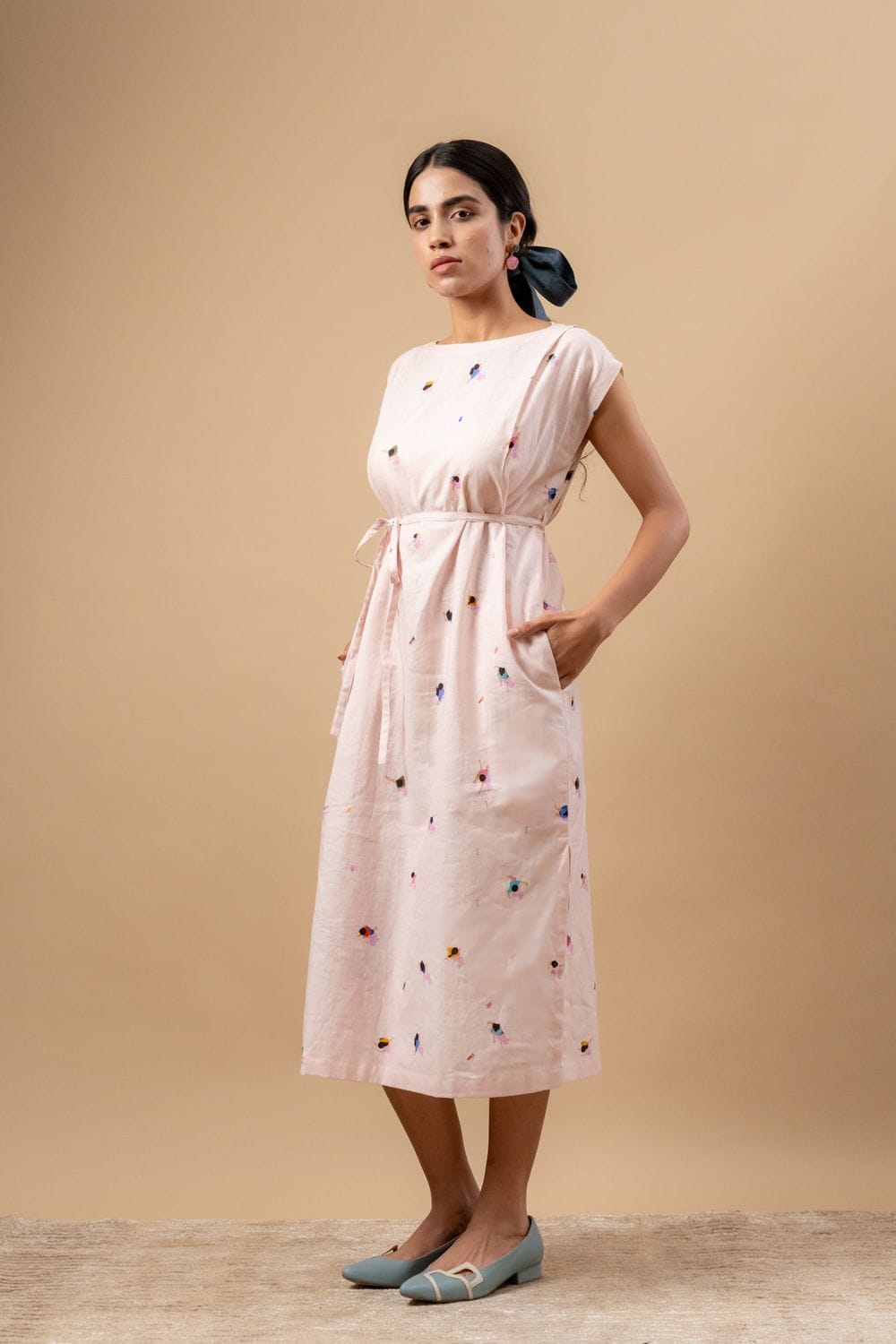 Doodlage Erna printed dress with vibrant floral pattern, short sleeves, and knee-length design, displayed on a hanger.