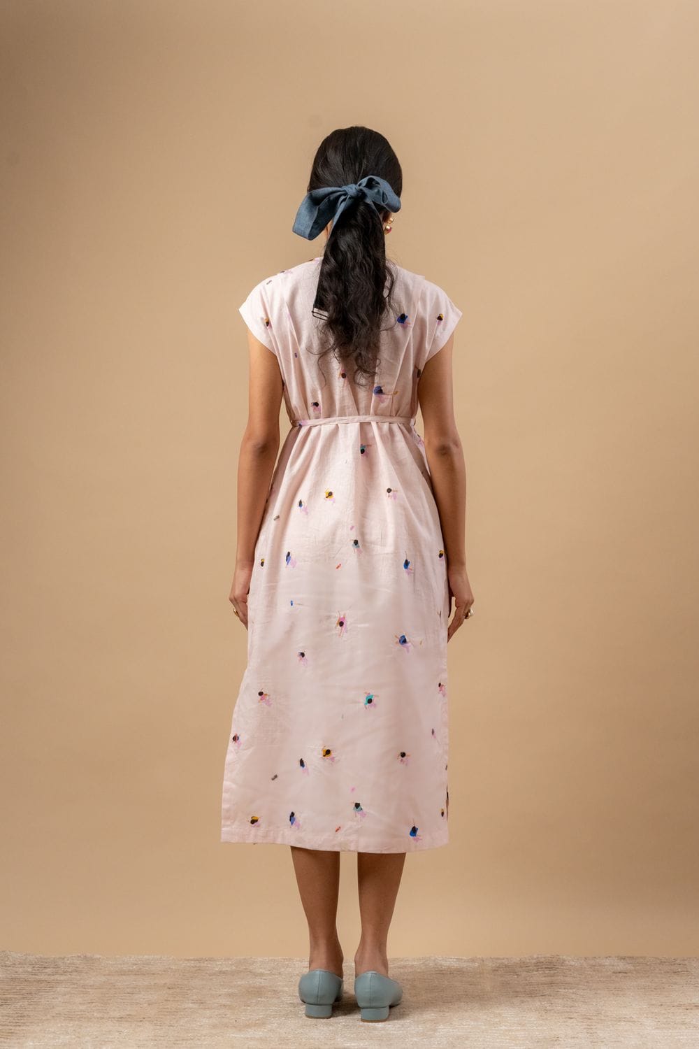 Doodlage Erna printed dress with colorful floral pattern, short sleeves, and knee-length fit, displayed on a hanger.