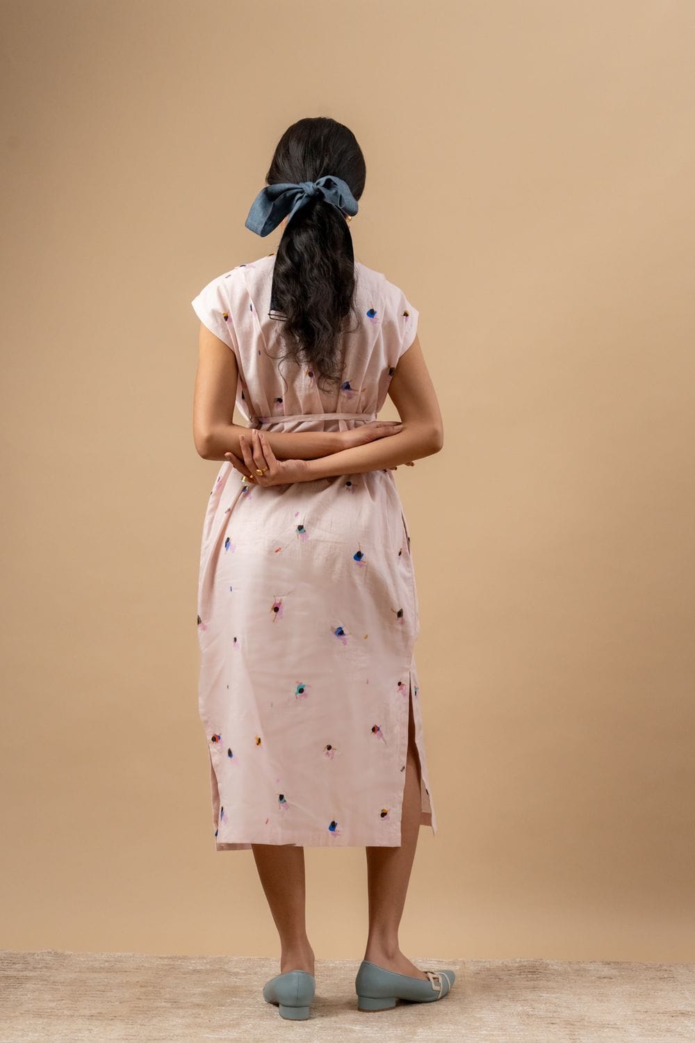 Doodlage Erna printed dress with vibrant patterns and flowy fabric, displayed on a hanger against a neutral background.