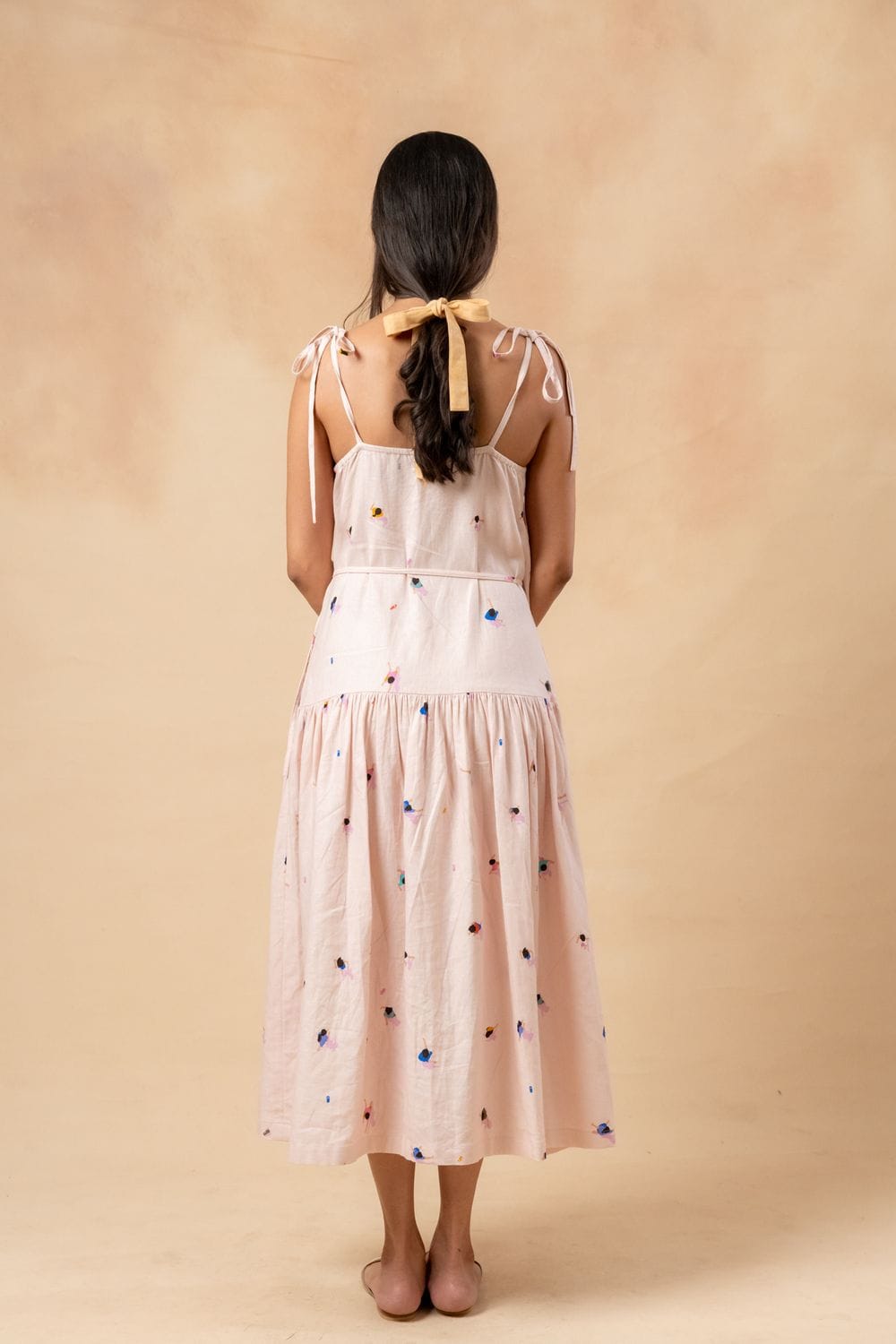 Doodlage crayon wrap dress in vibrant multicolor fabric, featuring a waist tie and knee-length fit, displayed on a mannequin.