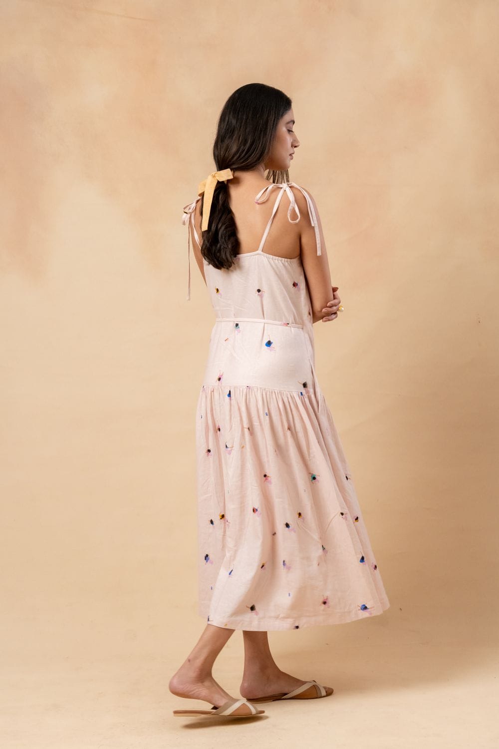 Doodlage crayon wrap dress in vibrant multicolor, with long sleeves and a fitted waist, displayed on a hanger.