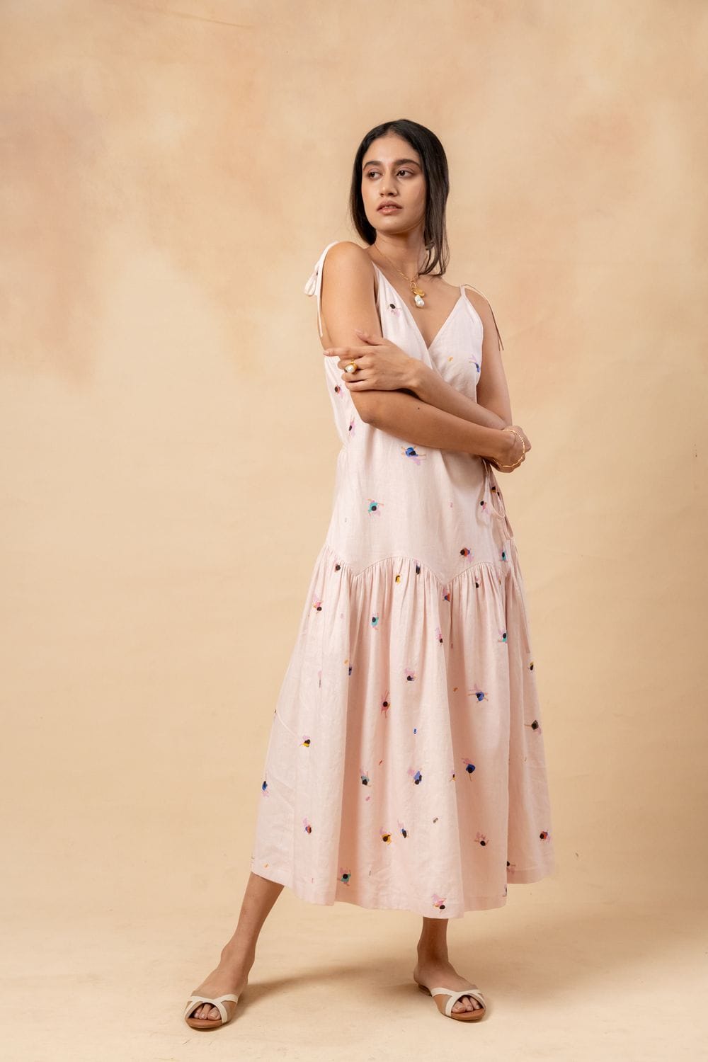 Doodlage crayon wrap dress in vibrant multicolor fabric, knee-length with long sleeves and a waist tie, stylish and comfortable.