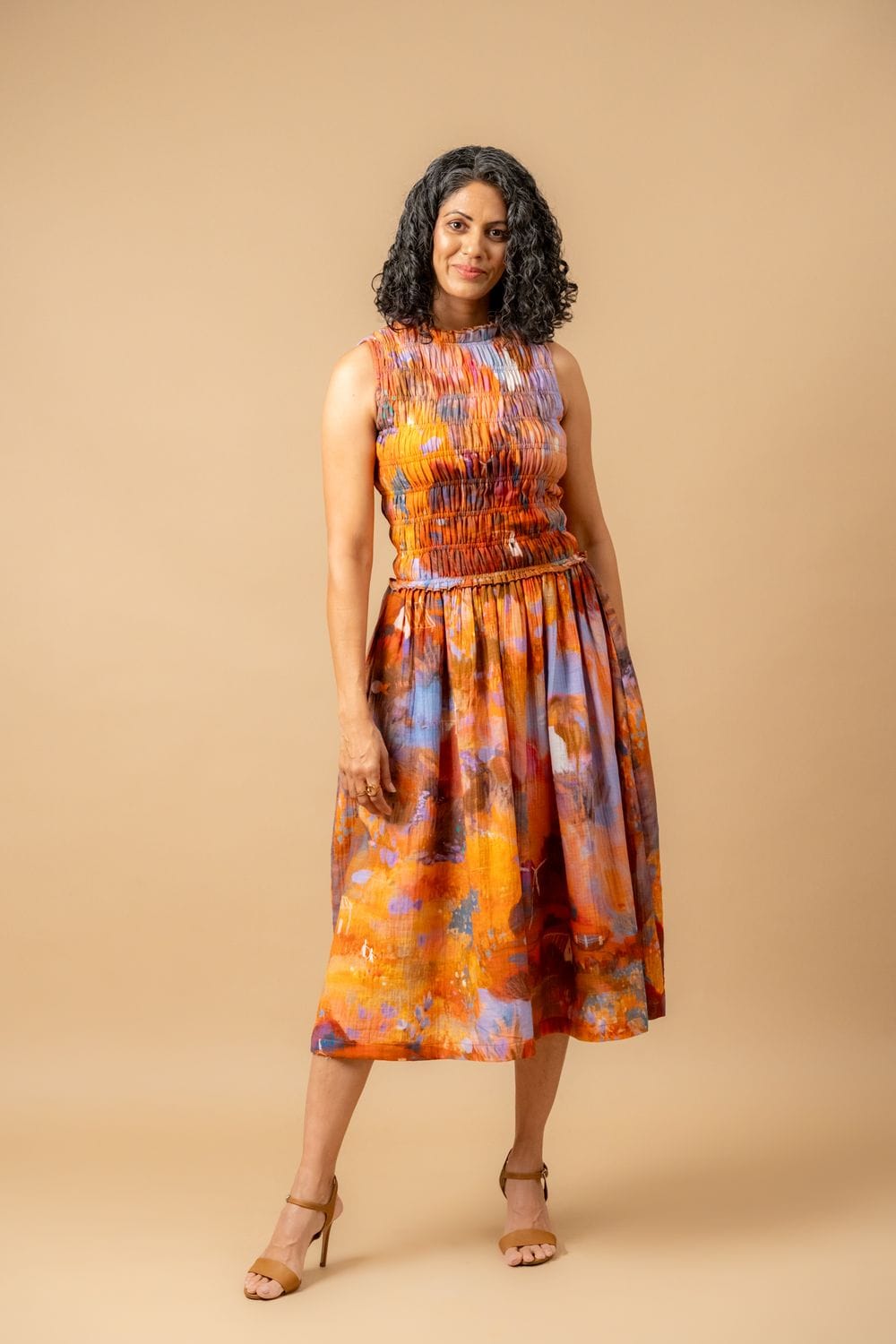 Doodlage Midsummer smocked dress in lightweight fabric with a fitted bodice, short puff sleeves, and floral print.
