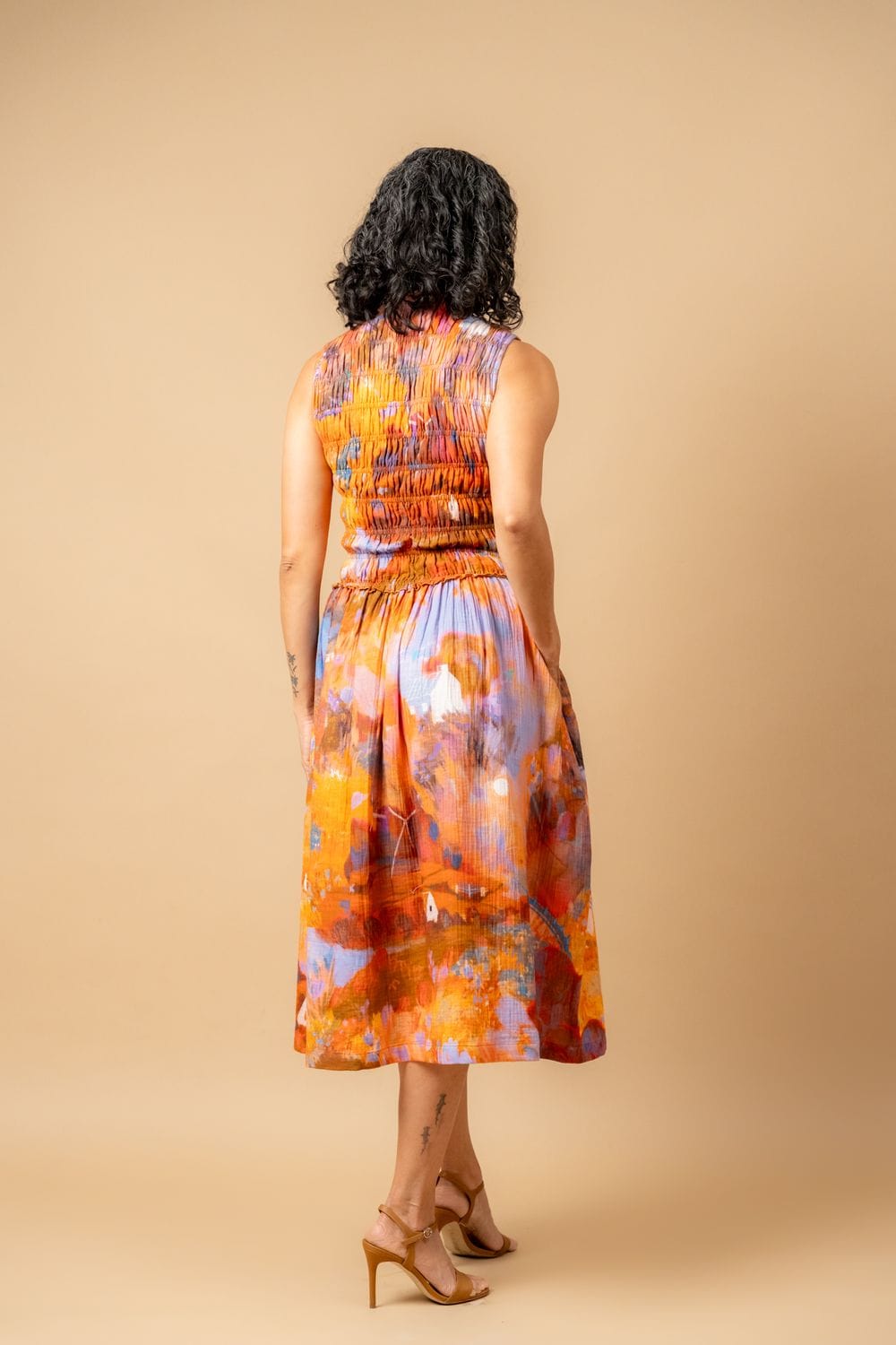Doodlage Midsummer smocked dress in lightweight fabric with floral pattern, featuring a fitted bodice and flowing skirt.