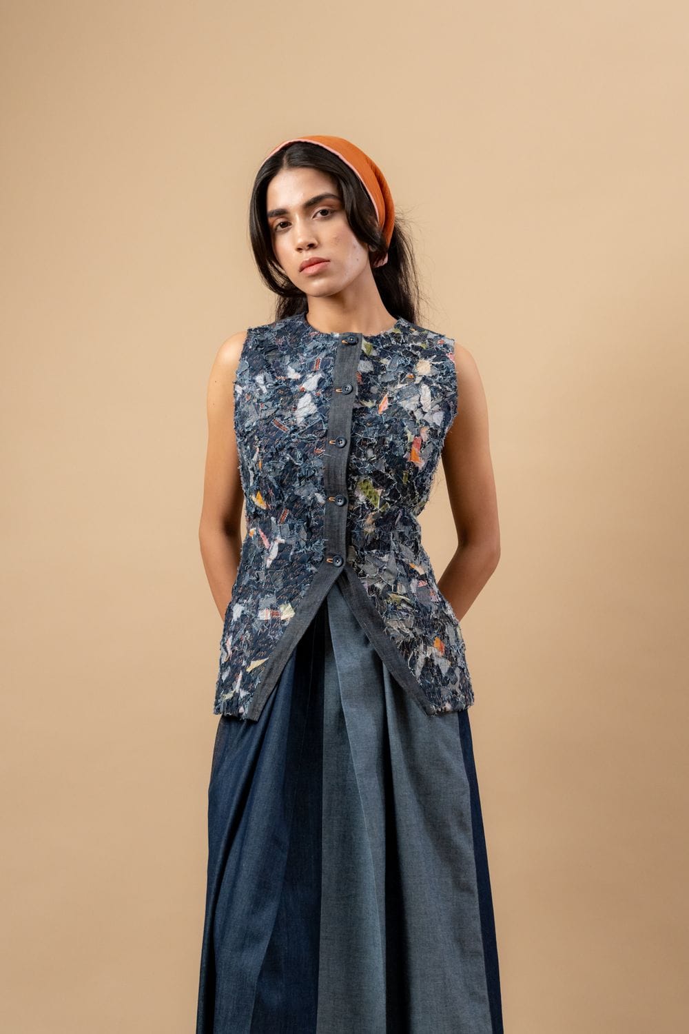 Upcycled denim waistcoat by Doodlage, featuring a stylish, eco-friendly design with button closure and patchwork details.