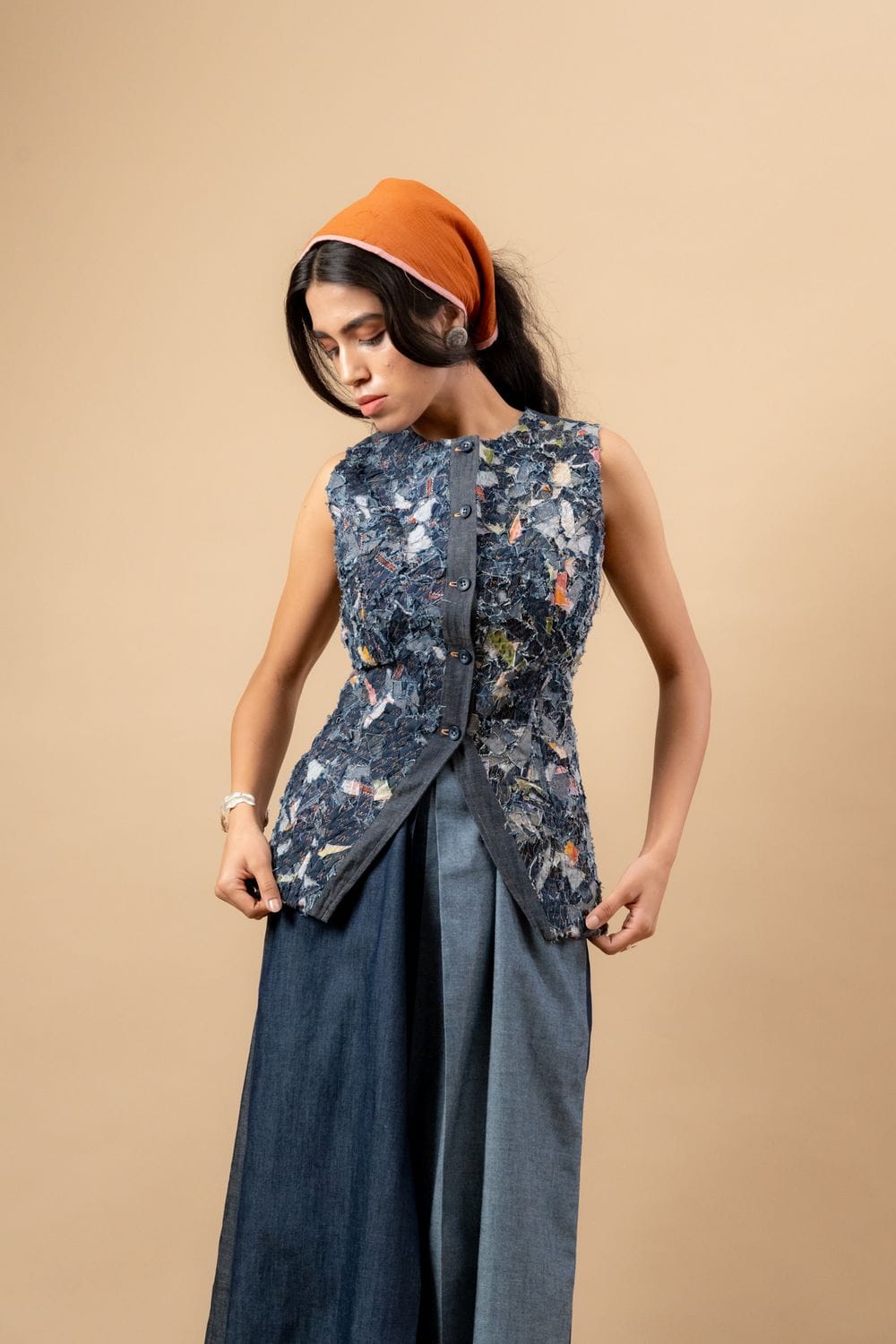 Upcycled denim waistcoat by Doodlage featuring a stylish, eco-friendly design with button closure and patchwork details.