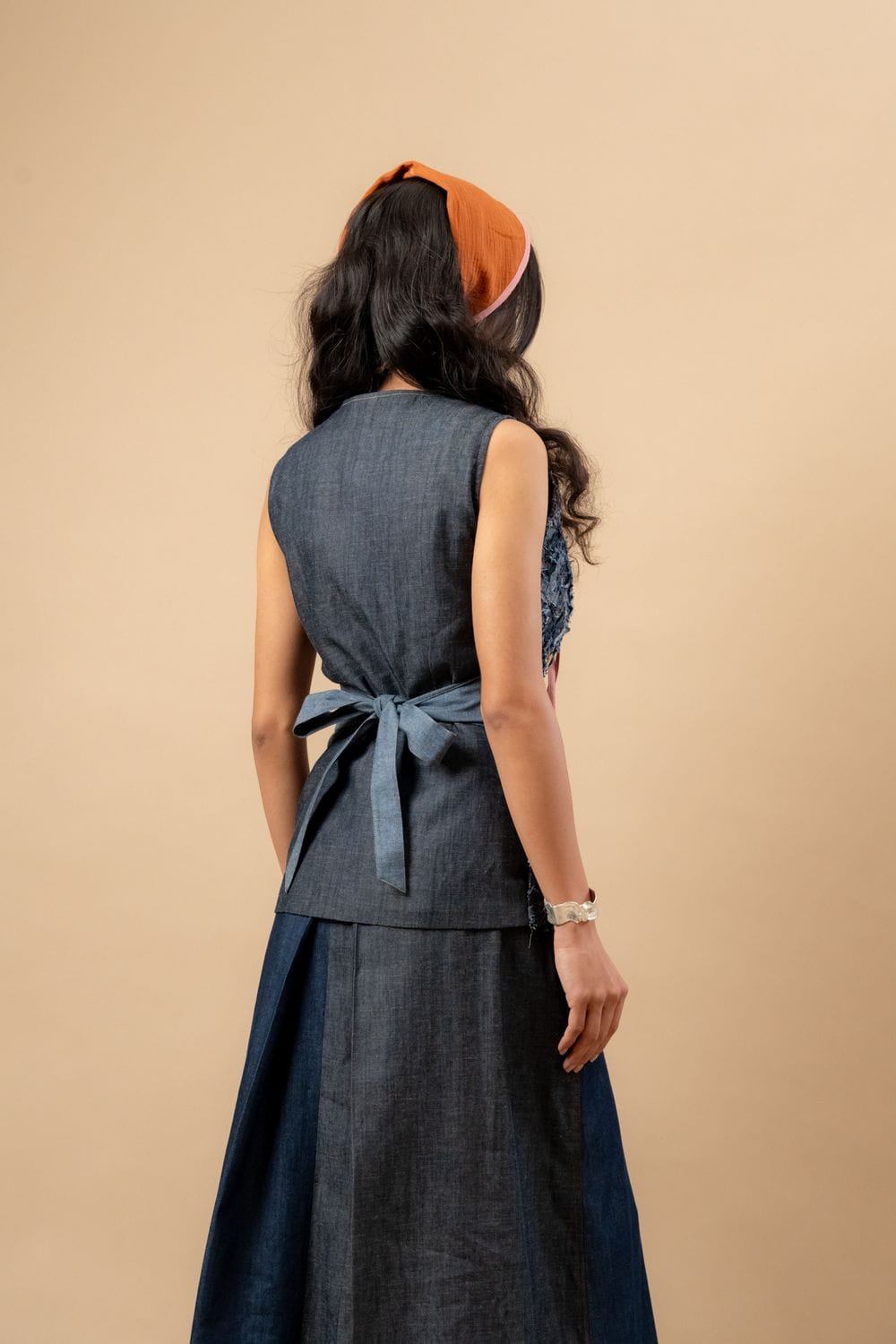Upcycled denim waistcoat by Doodlage featuring a stylish, eco-friendly design with front pockets and a button closure.