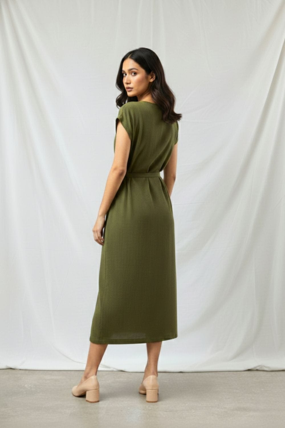 Doodlage Erna olive dress with long sleeves and relaxed fit, made from eco-friendly fabric, displayed on a hanger.