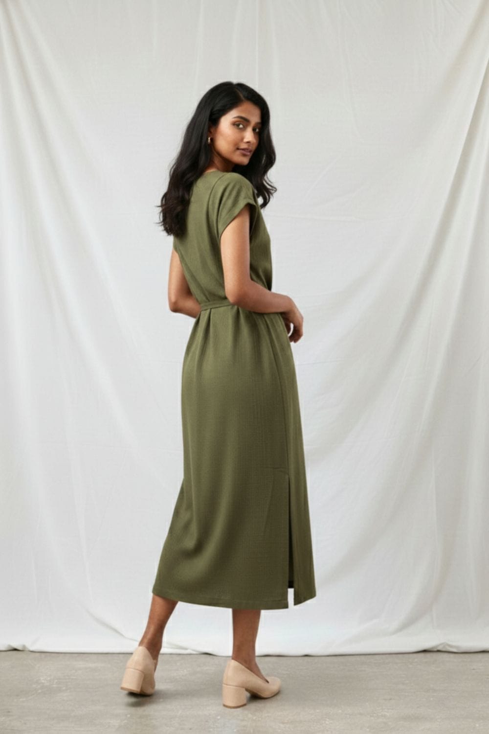 Doodlage Erna olive dress with flowy fabric, long sleeves, and a relaxed fit, displayed on a hanger against a neutral background.