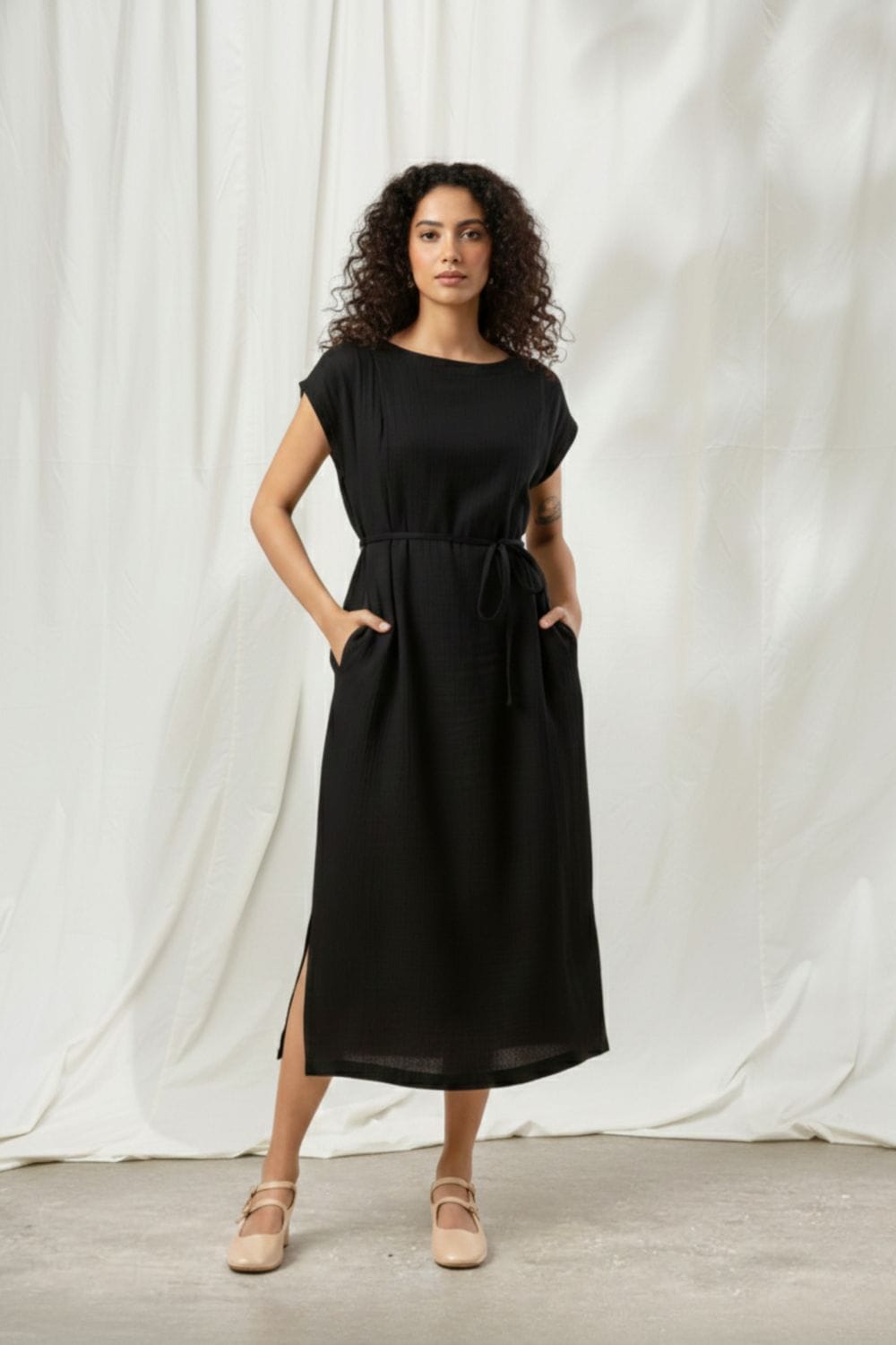 Black Erna dress by Doodlage, featuring a stylish, fitted design with subtle detailing, shown on a model.