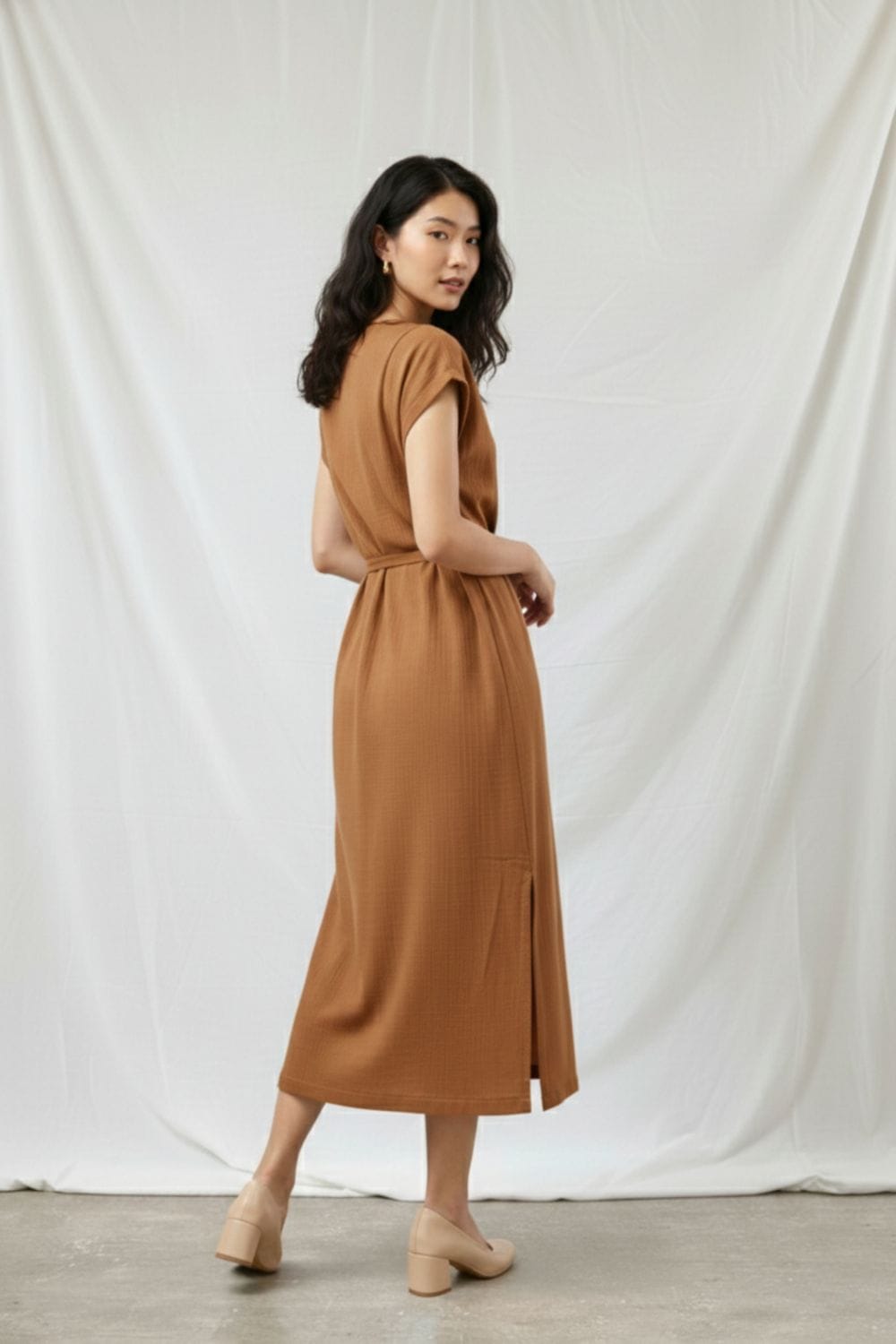Beige Erna dress by Doodlage featuring a relaxed fit, soft fabric, and stylish design, displayed on a hanger against a neutral background.