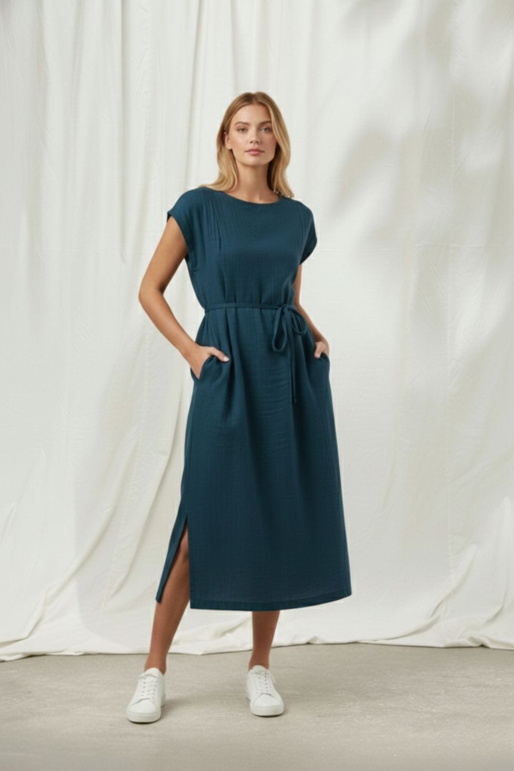 Midnight blue Doodlage Erna dress with long sleeves and a flowing silhouette, displayed on a hanger.
