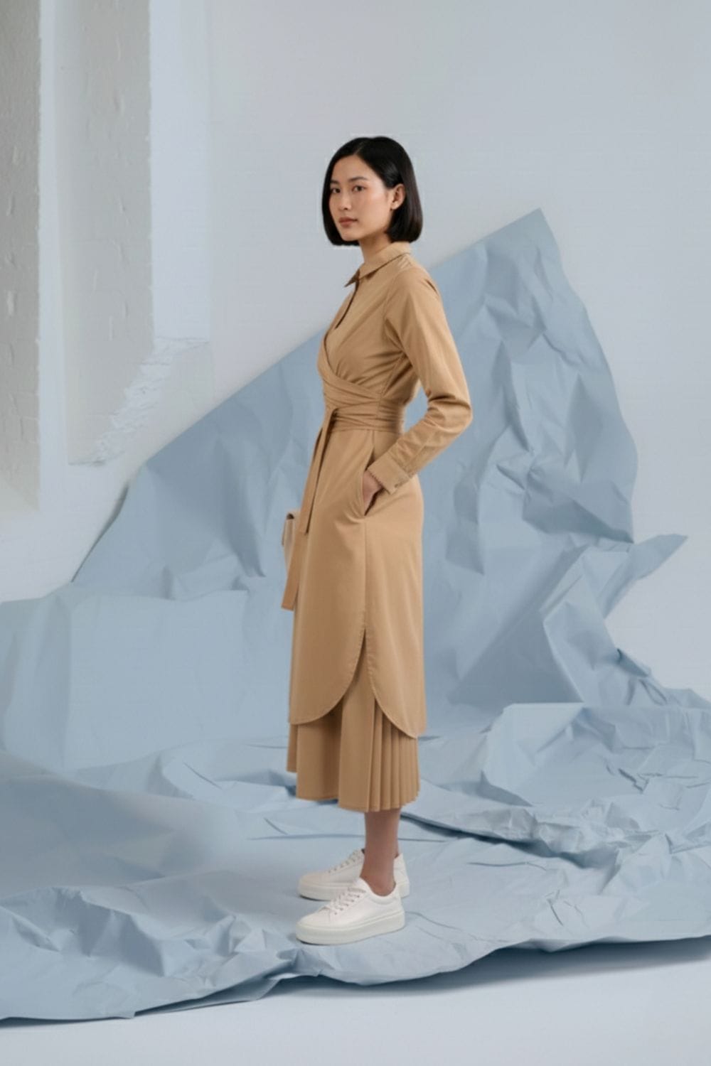Doodlage Thea beige shirt dress with long sleeves and button details, displayed on a hanger against a neutral background.