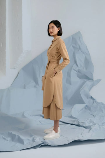 Doodlage Thea beige shirt dress with long sleeves and button details, displayed on a hanger against a neutral background.