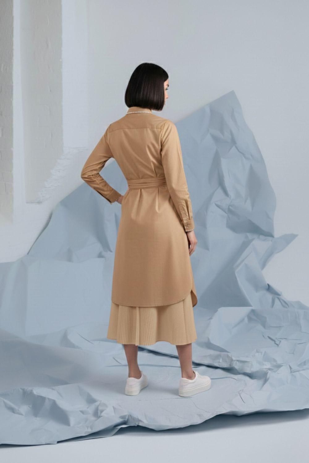 Doodlage Thea beige shirt dress with collar and button-front, long sleeves, and waist tie, displayed on a hanger.