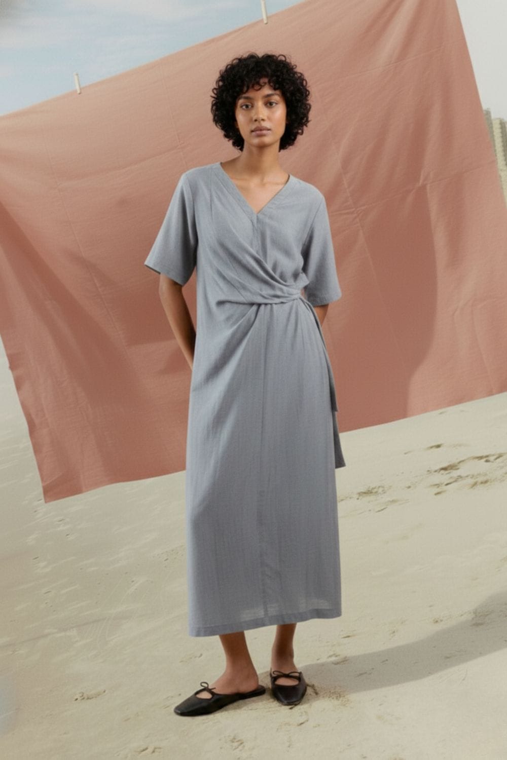 Doodlage Eden pale blue dress with long sleeves and a flowy silhouette, displayed on a hanger against a neutral background.