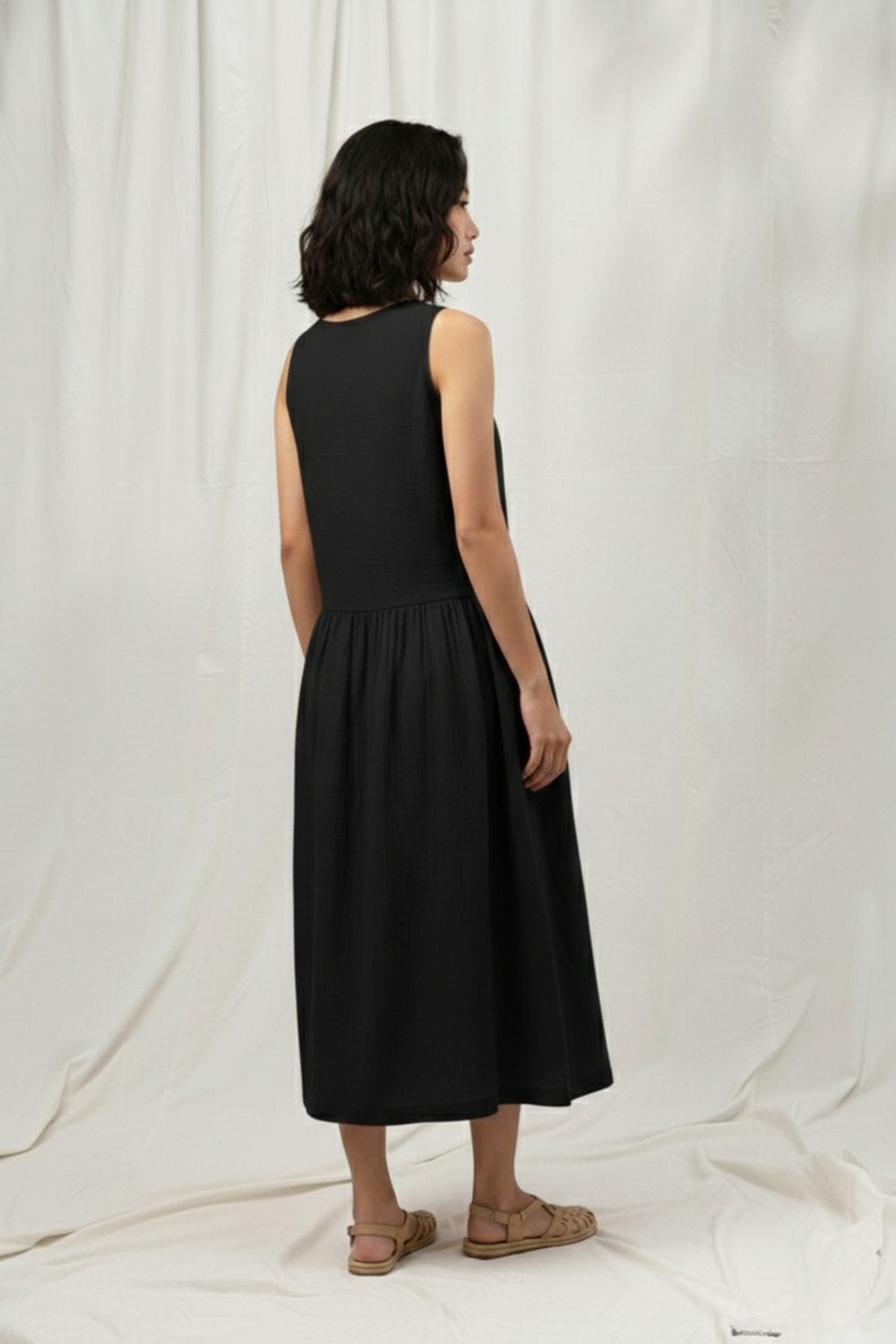 Black Susan dress by Doodlage, showcasing a stylish, fitted dress with elegant design and detailed fabric texture.