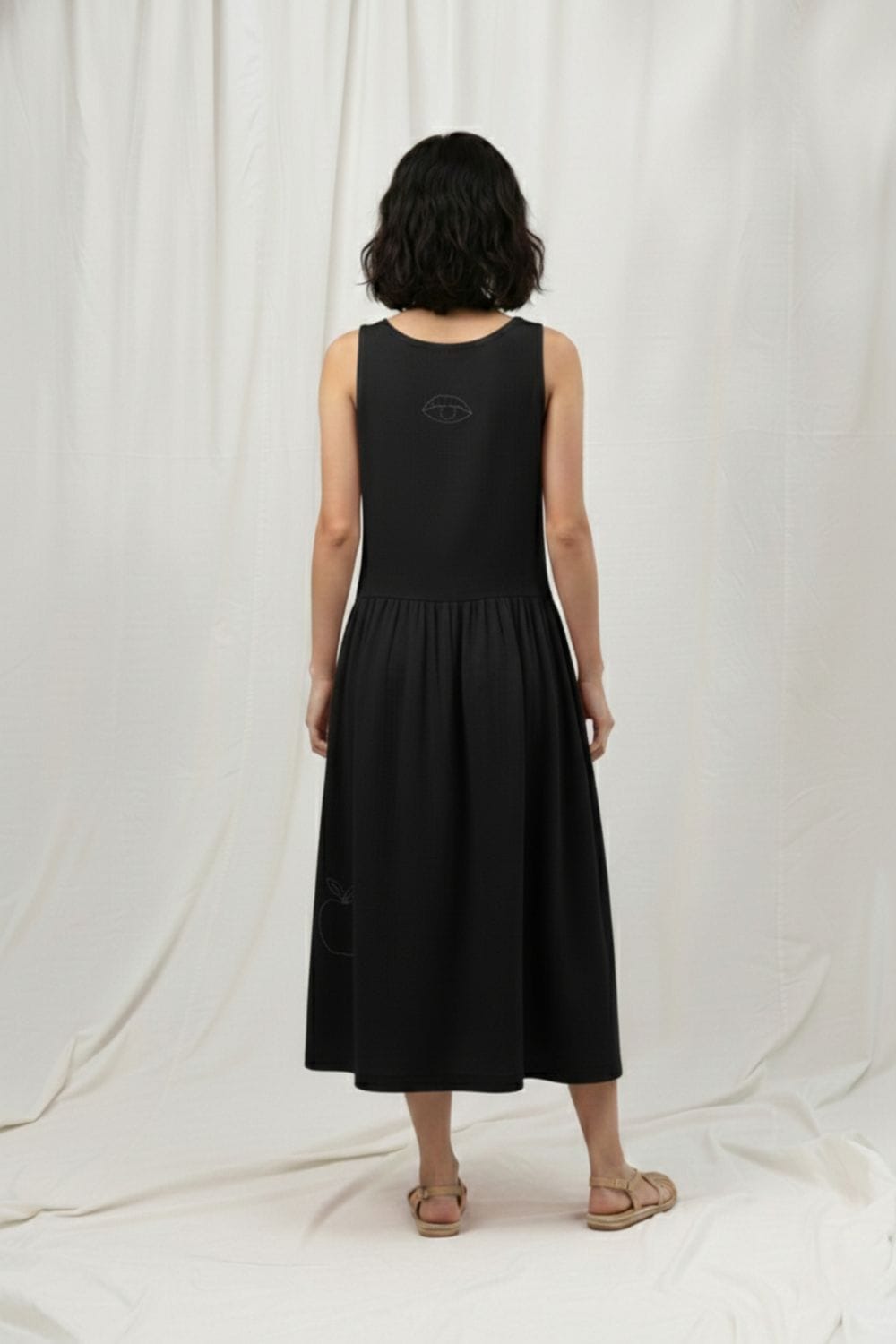 Susan black dress by Doodlage, stylish sleeveless dress with a fitted silhouette, displayed on a hanger against a neutral background.