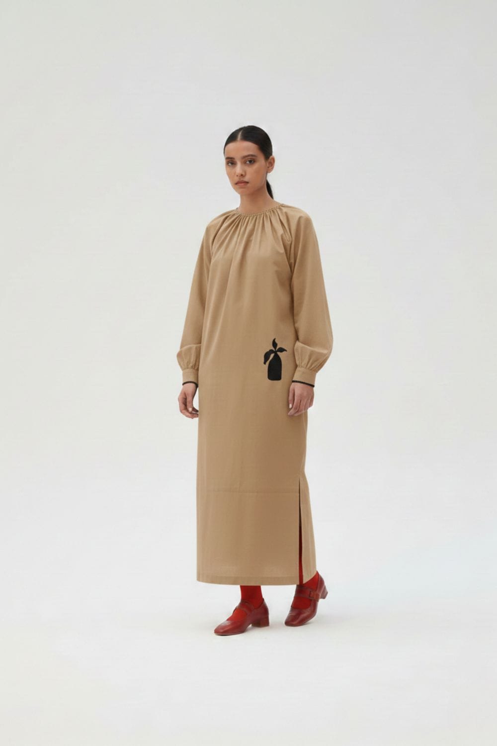 Astrid beige Doodlage dress with a relaxed fit, featuring soft fabric and subtle detailing, displayed on a hanger.