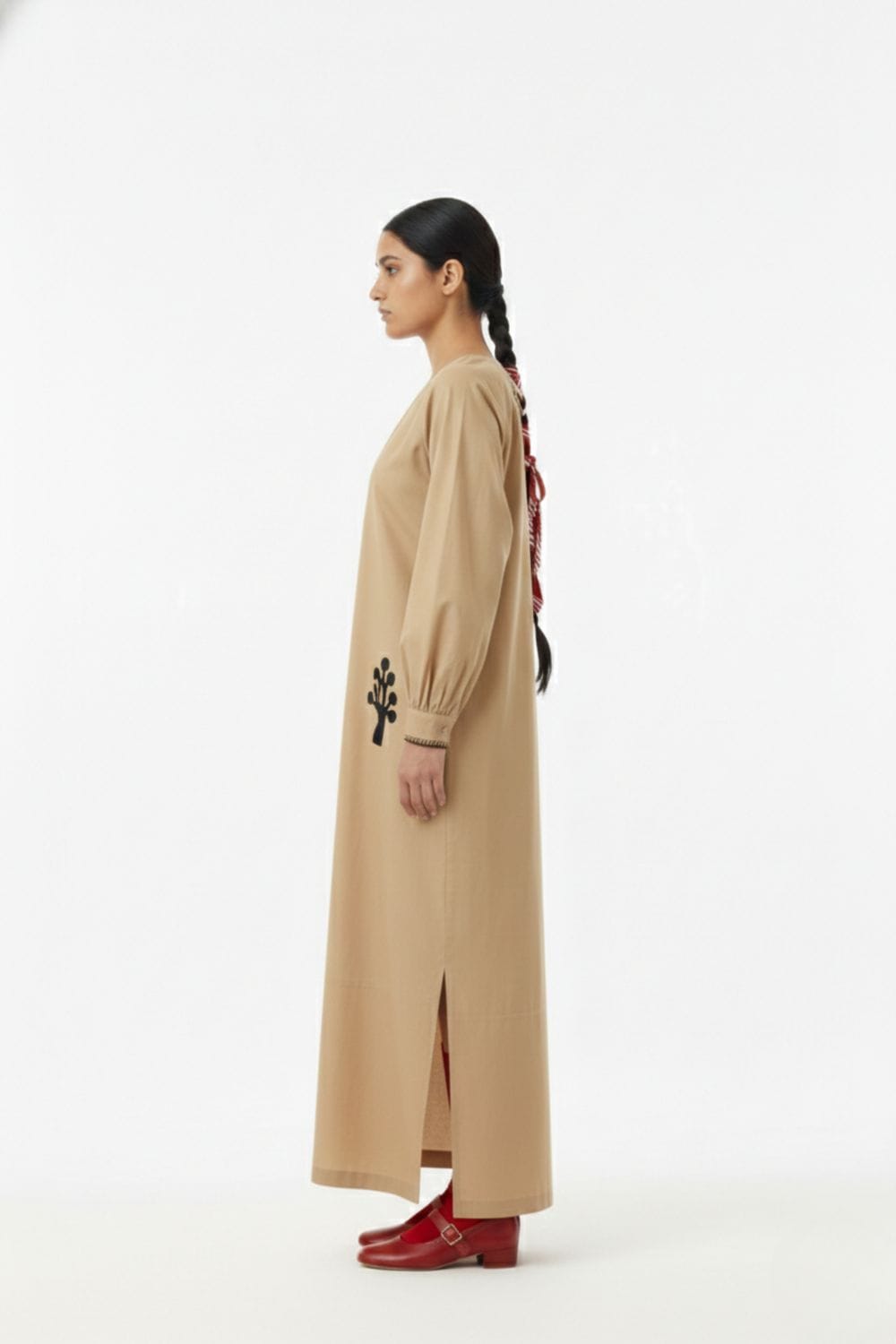 Astrid beige dress by Doodlage featuring a flowy silhouette and subtle fabric texture, displayed on a mannequin.