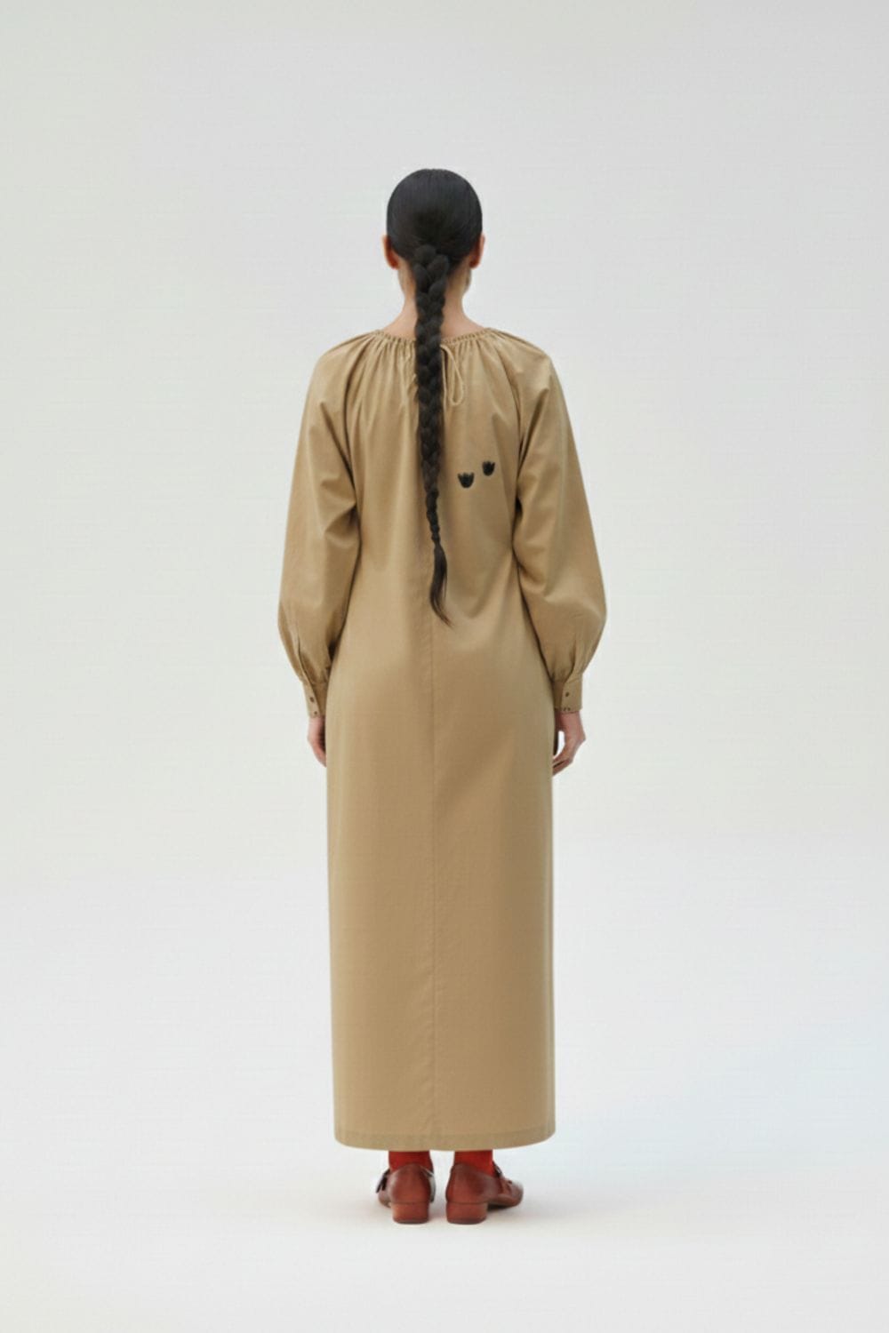 Astrid beige dress by Doodlage featuring a flowy silhouette and elegant fabric, displayed on a hanger.