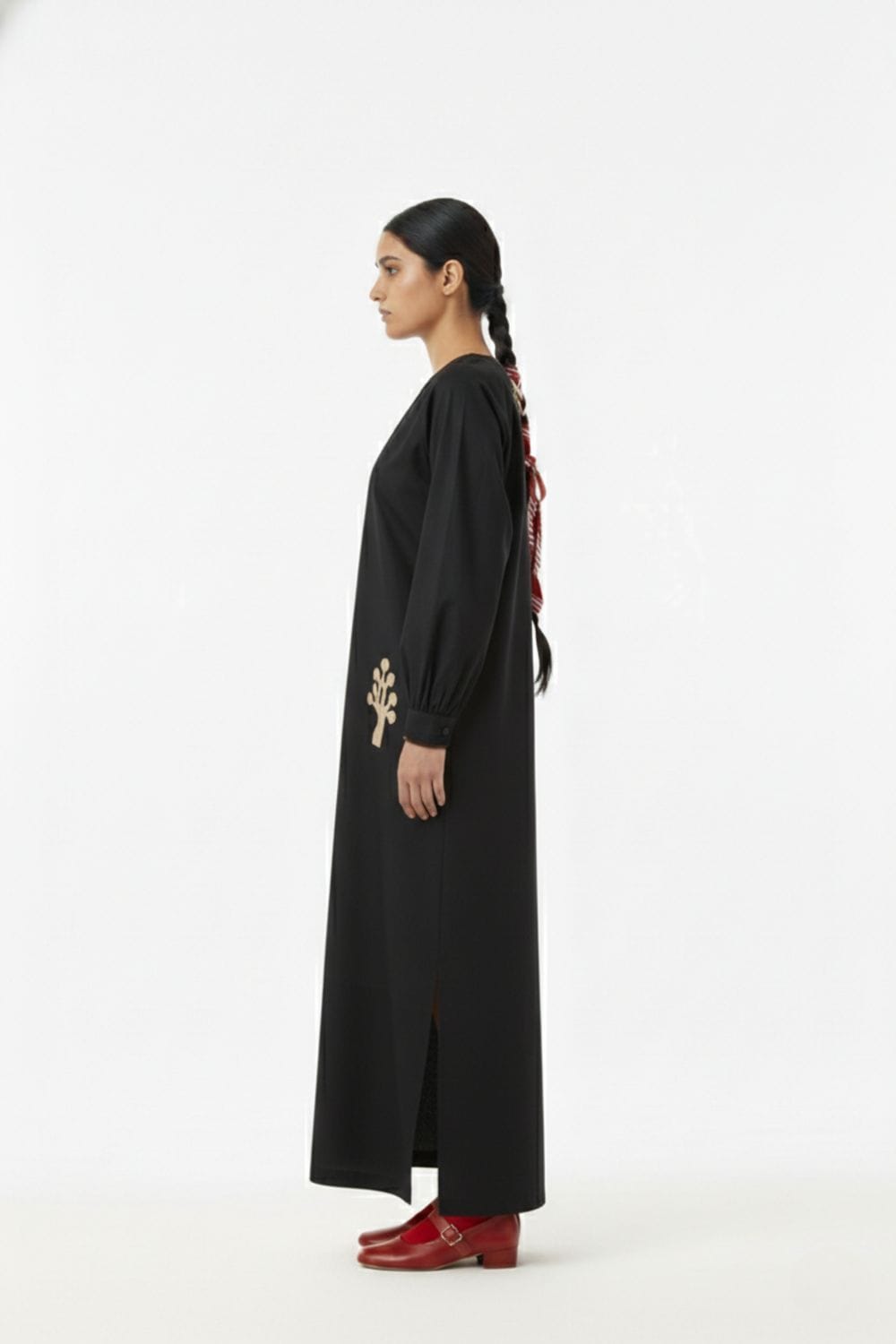 Astrid black dress by Doodlage featuring a stylish silhouette and elegant design, shown on a hanger against a plain background.
