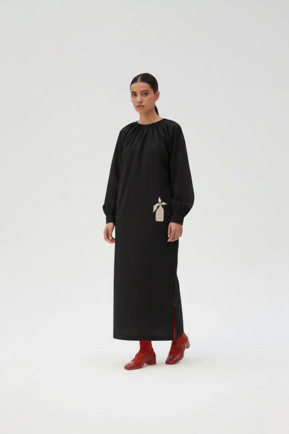 Black Astrid dress by Doodlage featuring a stylish, fitted design with long sleeves and a round neckline.