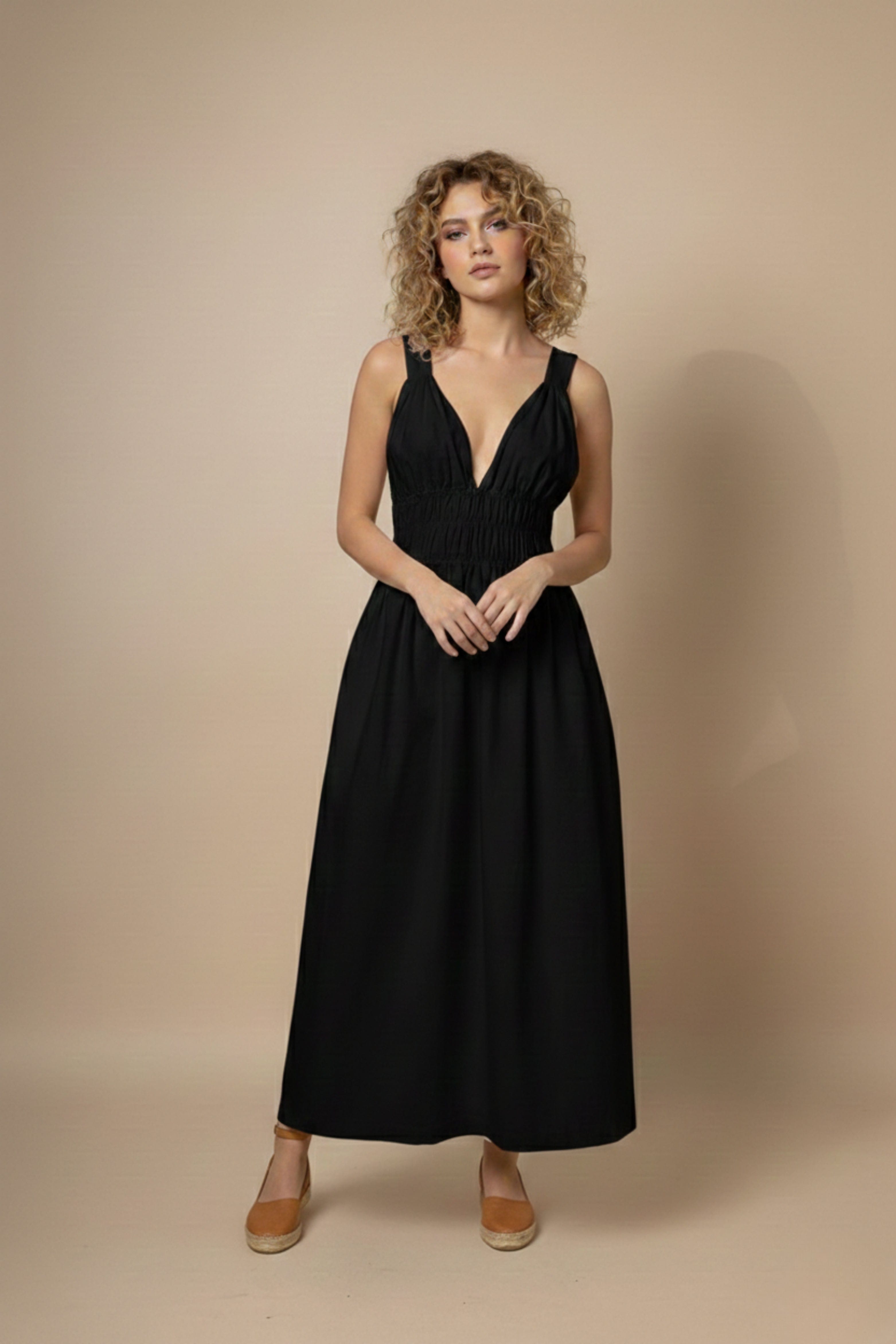 Black Doodlage August dress with a fitted silhouette, sleeveless design, and subtle textured fabric for a chic, modern look.