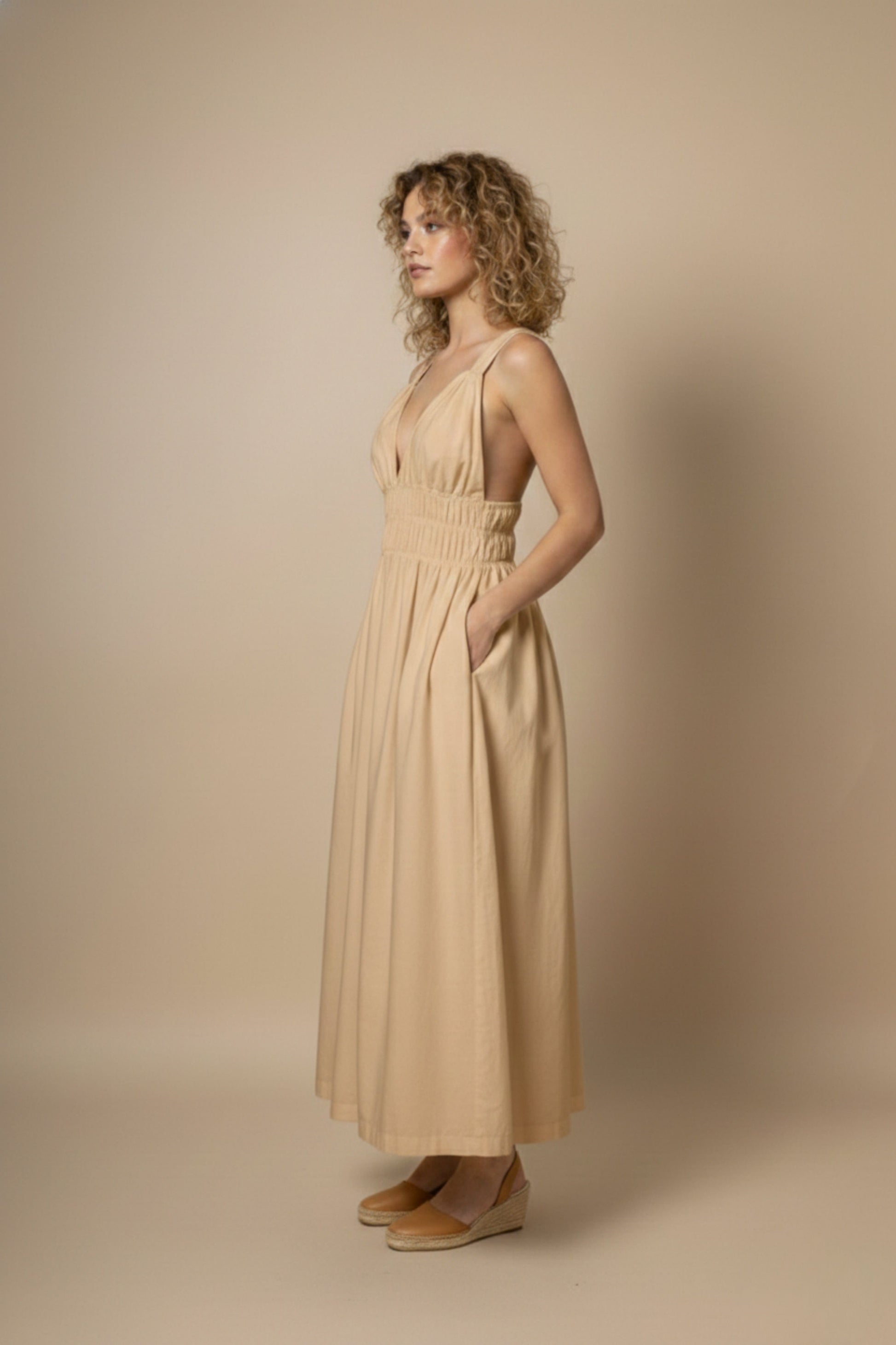 Doodlage August beige dress, lightweight and stylish, displayed on a hanger with natural fabric texture and simple design.