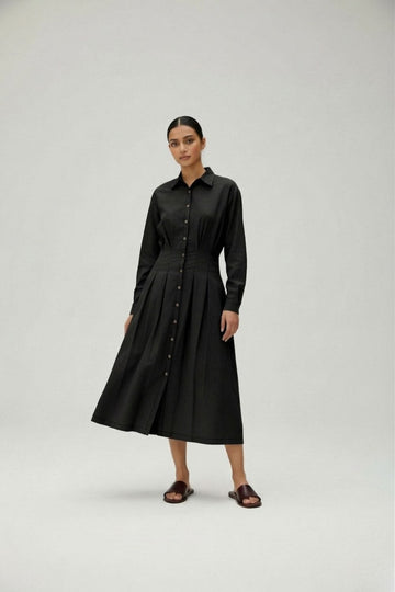 Black Doodlage Cecile dress shown on a model, featuring a simple yet elegant design with long sleeves and a knee-length hem.