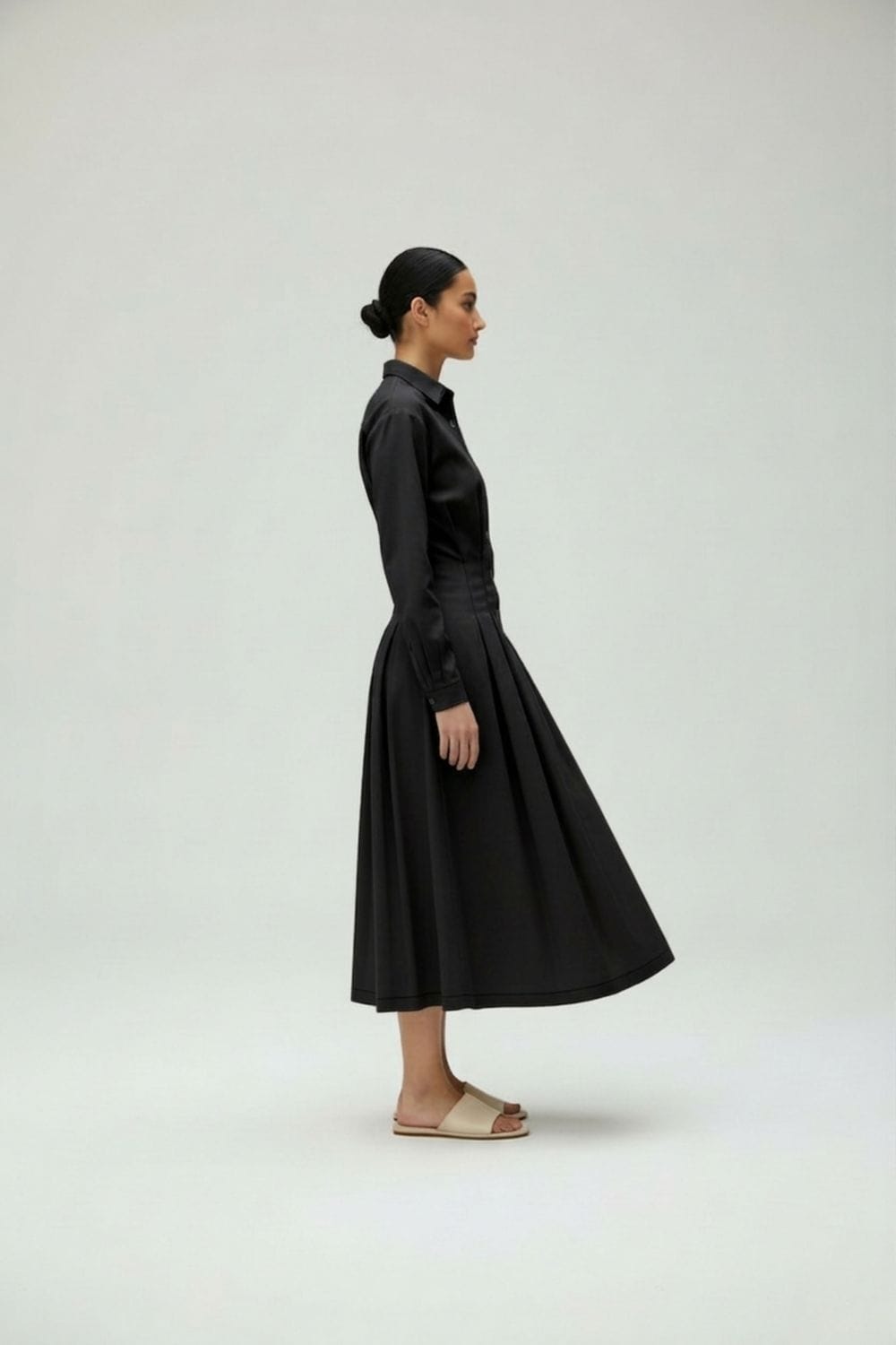 Black Doodlage Cecile dress shown on a model, featuring a simple yet elegant design with long sleeves and a knee-length hem.
