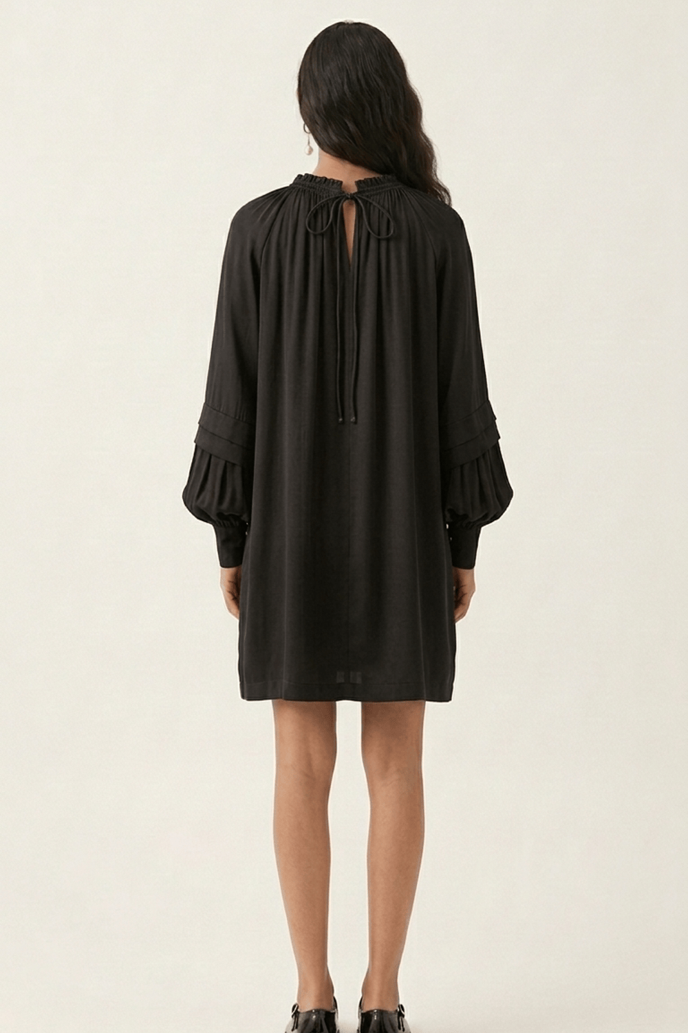 Black Alice dress by Doodlage featuring a fitted silhouette and stylish design, shown on a model.