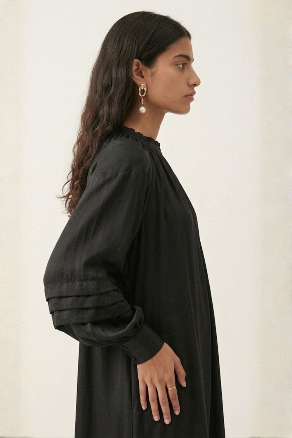Black Alice dress by Doodlage, stylish and elegant, shown on a mannequin with detailed fabric texture and classic fit.