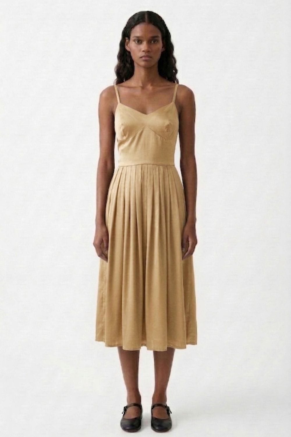 Mary Sand Dress by Doodlage, lightweight dress with a relaxed fit and subtle detailing, shown on a hanger.