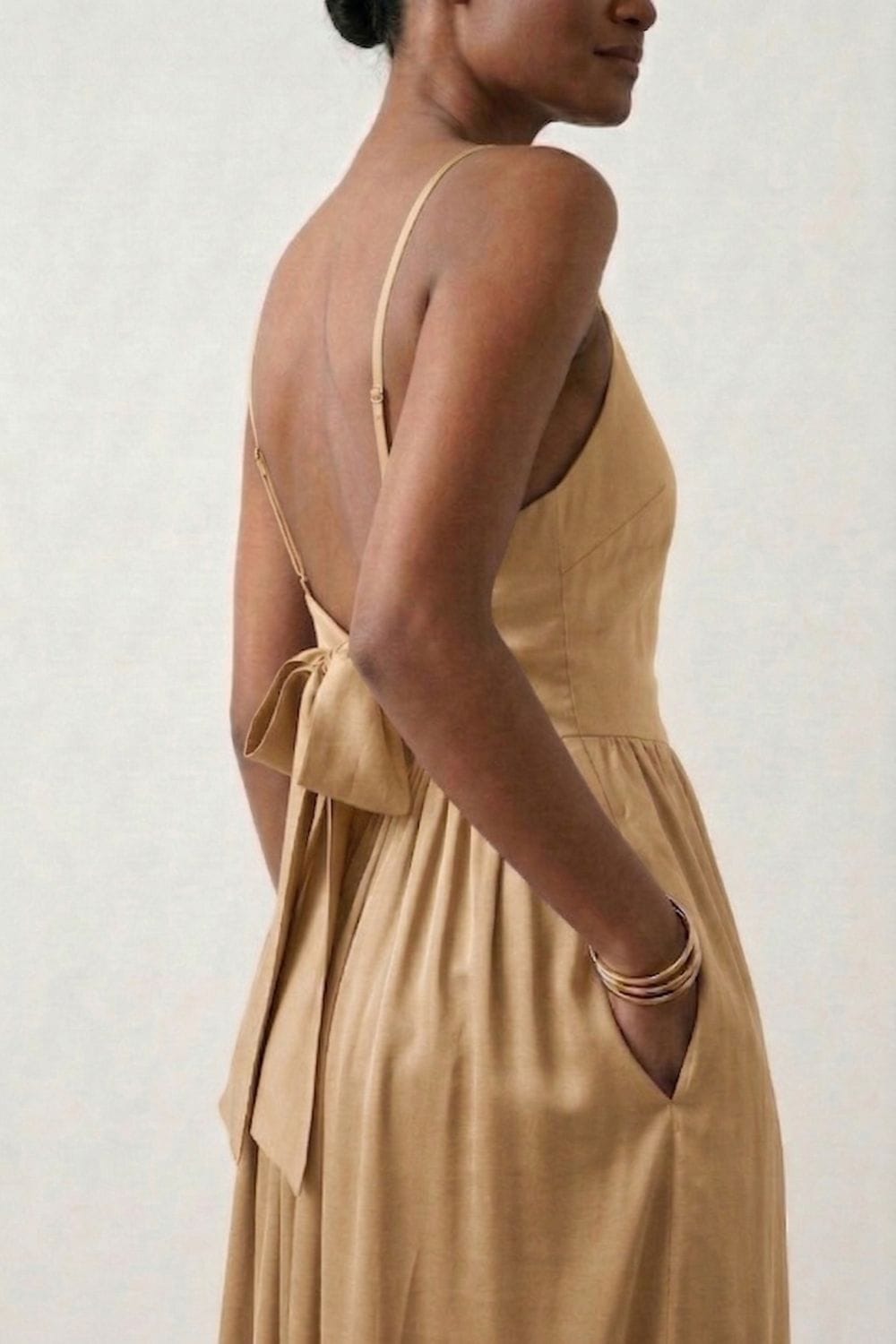 Doodlage Mary sand dress with flowing fabric, scoop neckline, and short sleeves, styled for casual or summer wear.