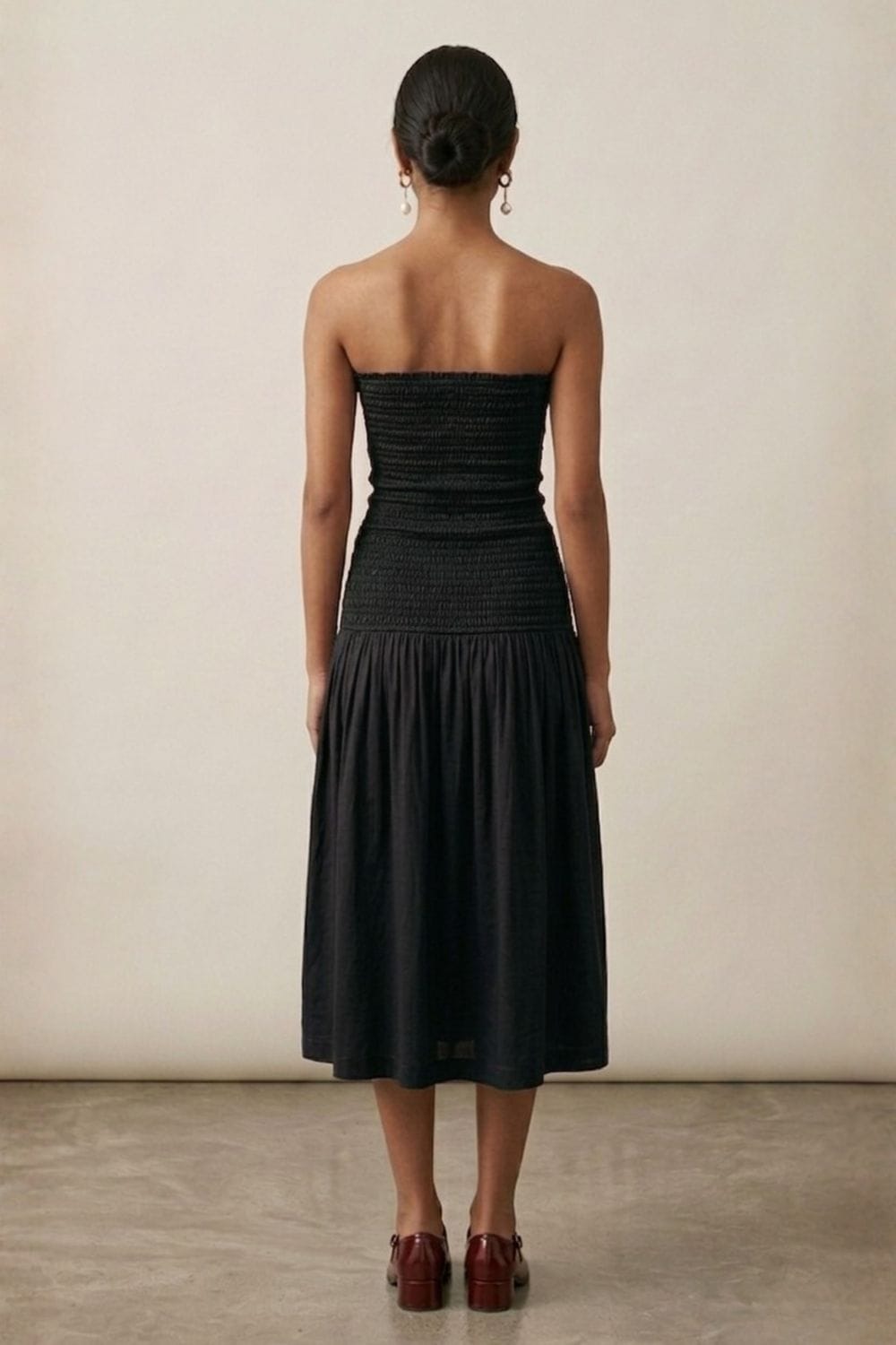 Black cherry dress by Doodlage featuring a fitted silhouette and elegant design, shown on a mannequin.