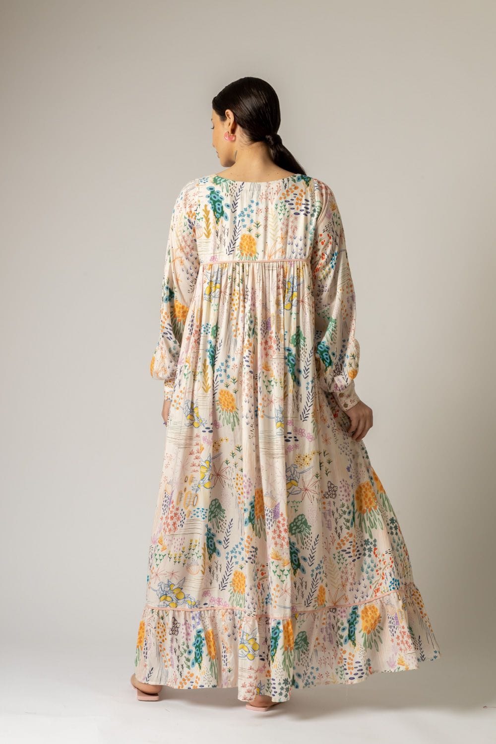 Doodlage Yayoi printed dress with vibrant floral pattern, short sleeves, and knee-length design on a model.