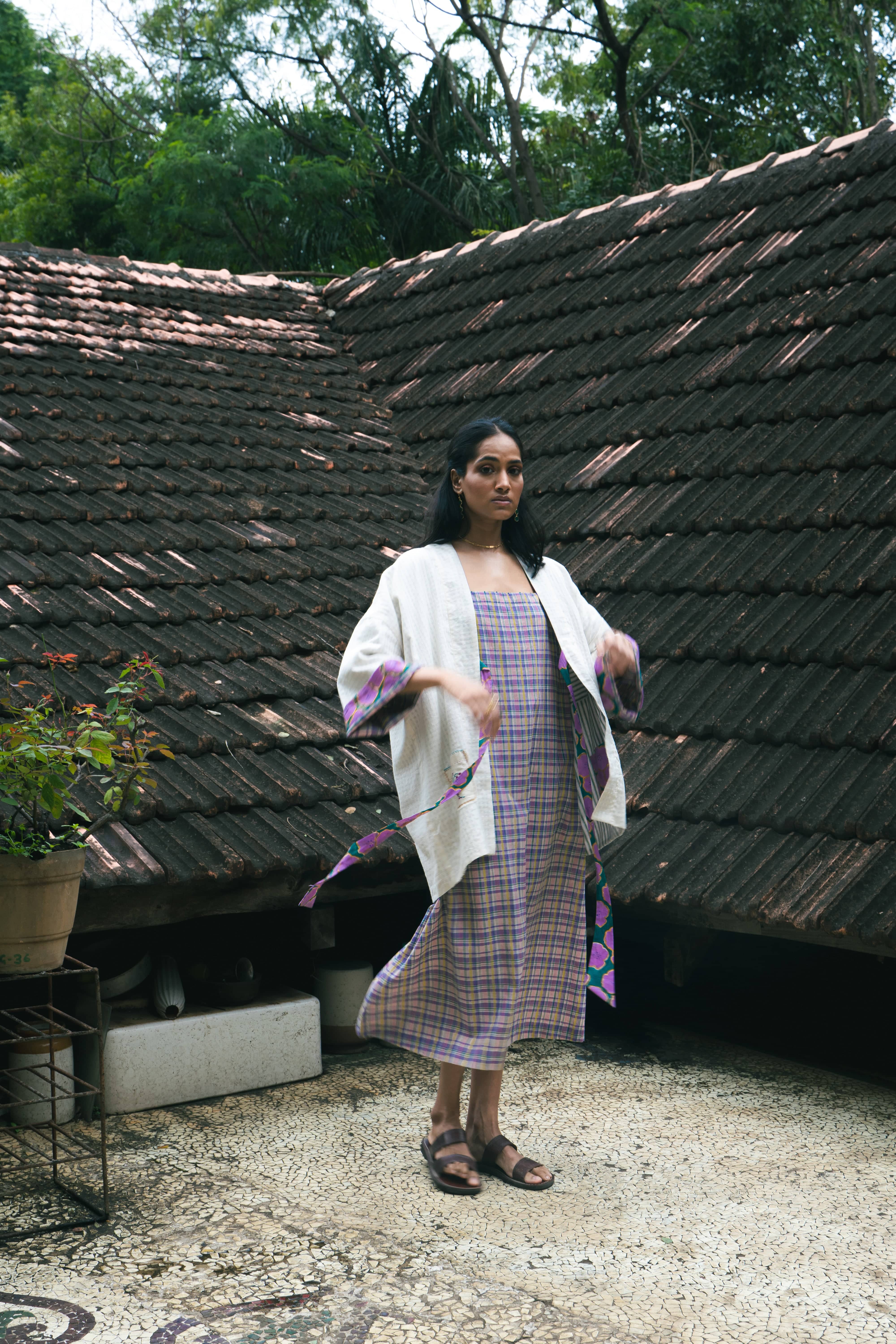 Deeta Meadow dress shown on a hanger with floral pattern and flowing fabric, perfect for casual or summer wear.